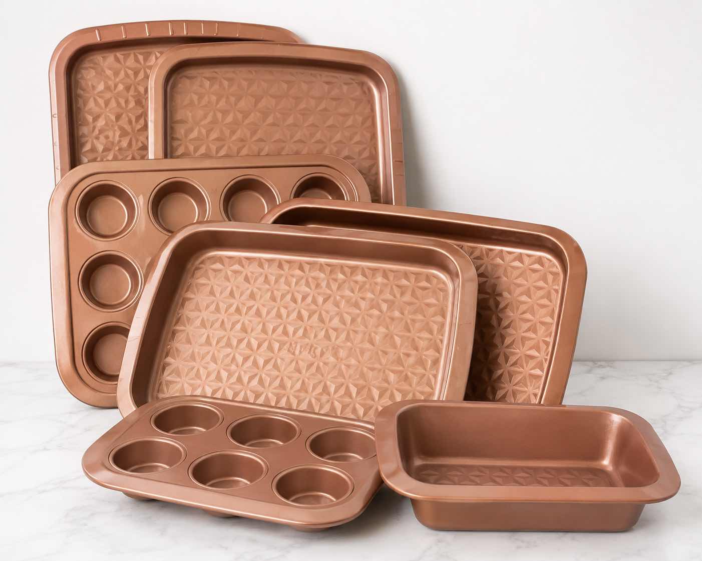 View 1 of ROSE GOLD NONSTICK BAKEWARE SET WITH BAKING PANS, MUFFIN PANS & LOAF PAN
COORDINATING METALLIC FINISH WITH TEXTURED BAKING SURFACES
ESTIMATED RETAIL VALUE: $75–$100