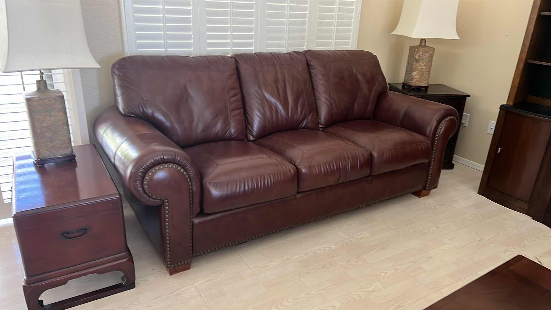 Photo 2 of BURGUNDY LEATHER SOFA W BRASS TACK TRIM 87” x 38”