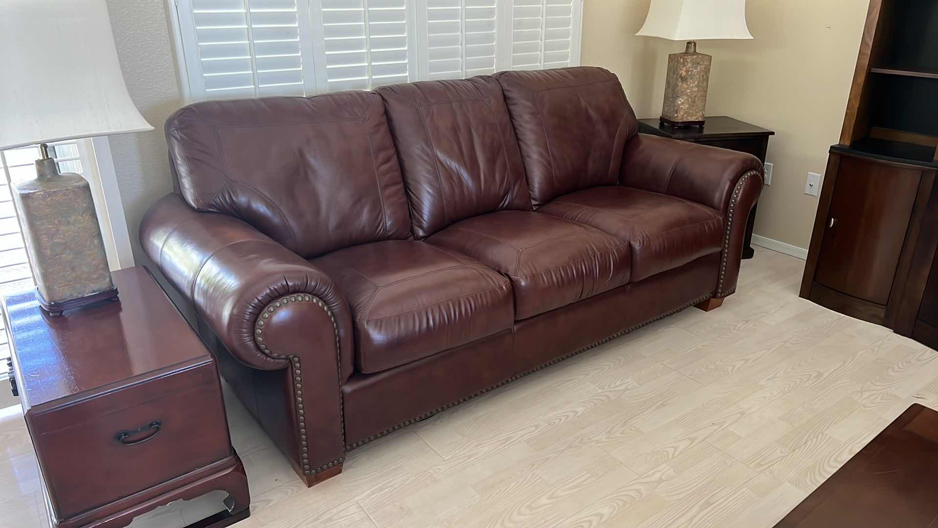 Photo 4 of BURGUNDY LEATHER SOFA W BRASS TACK TRIM 87” x 38”