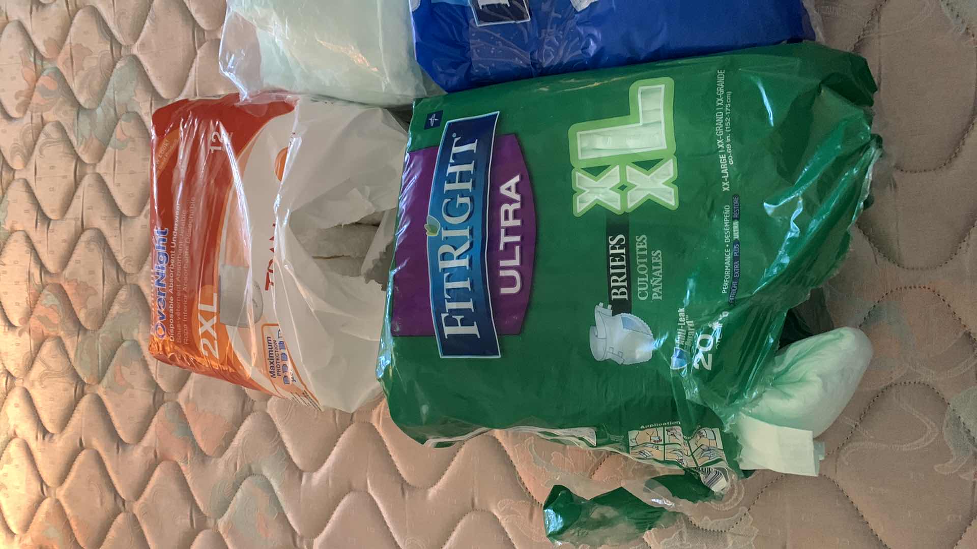 Photo 1 of OPEN PACKAGES OF ASSORTED PADS AND PROTECTIVE UNDERWEAR