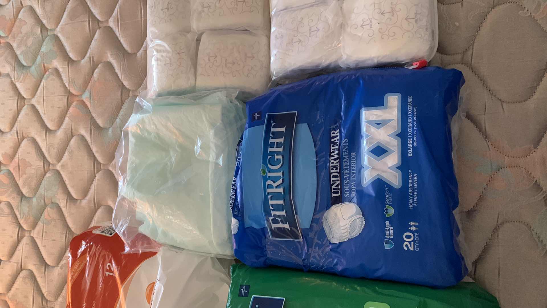 Photo 1 of OPEN PACKAGES OF ASSORTED PADS AND PROTECTIVE UNDERWEAR