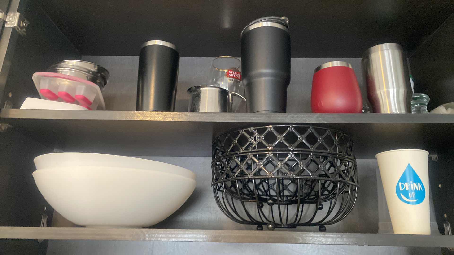 Photo 1 of CONTENTS KITCHEN CABINET-2 SHELVES BOWLS, 2 BLACK FRUIT BASKETS, TRAVEL CUPS