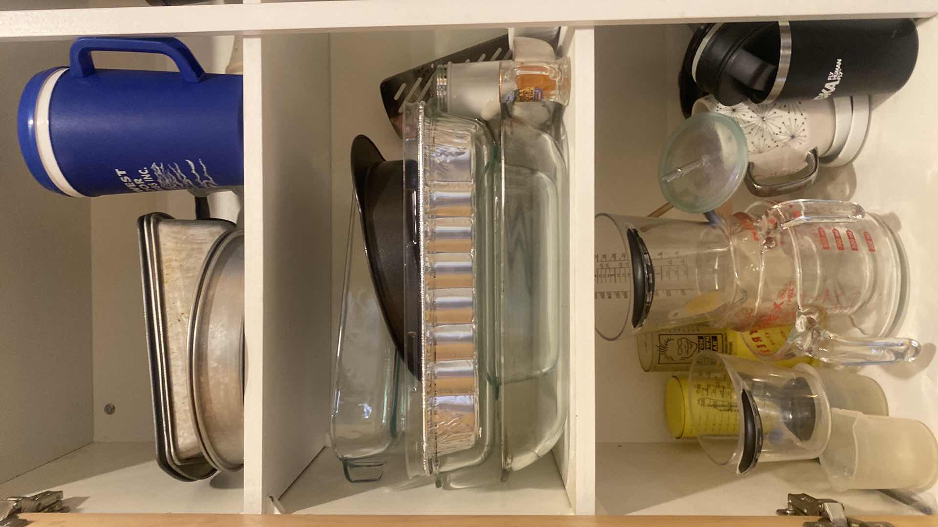 Photo 1 of CONTENTS OF KITCHEN CABINET - BAKEWARE & MEASURING CUPS
