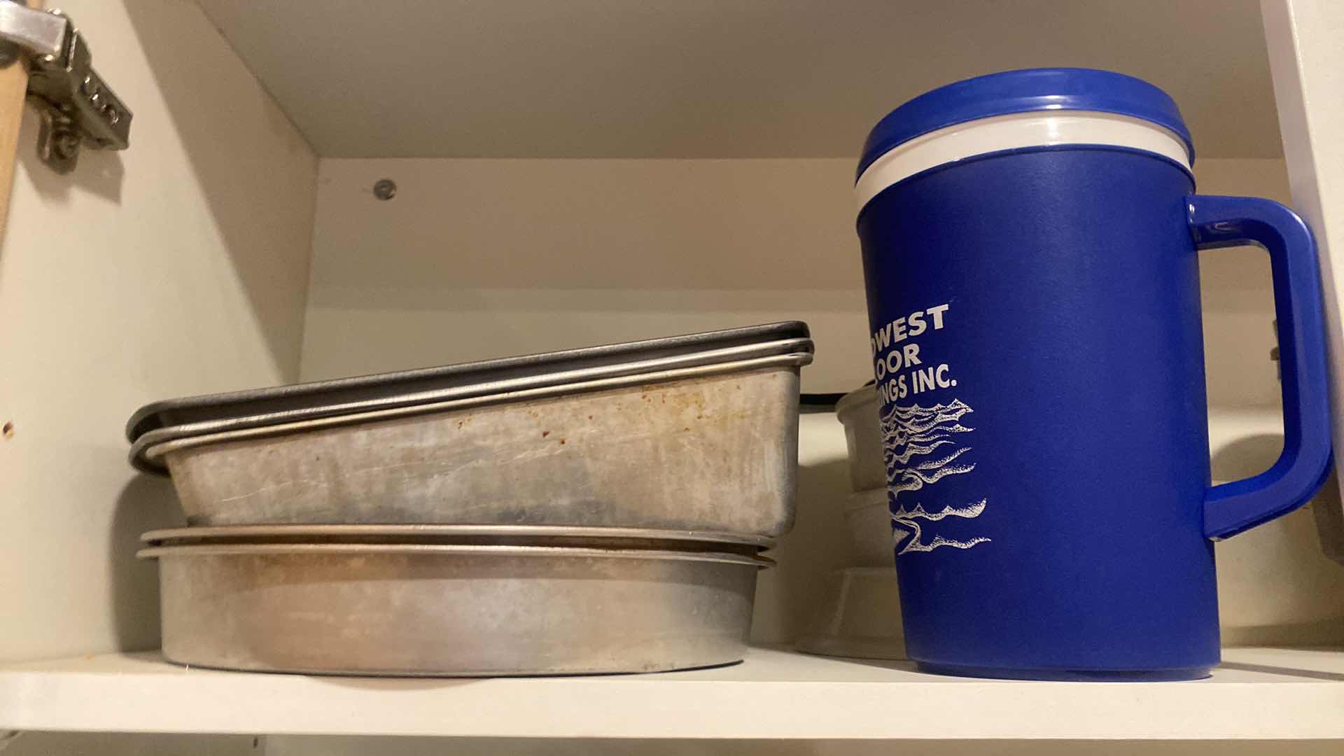 Photo 1 of CONTENTS OF KITCHEN CABINET - BAKEWARE & MEASURING CUPS