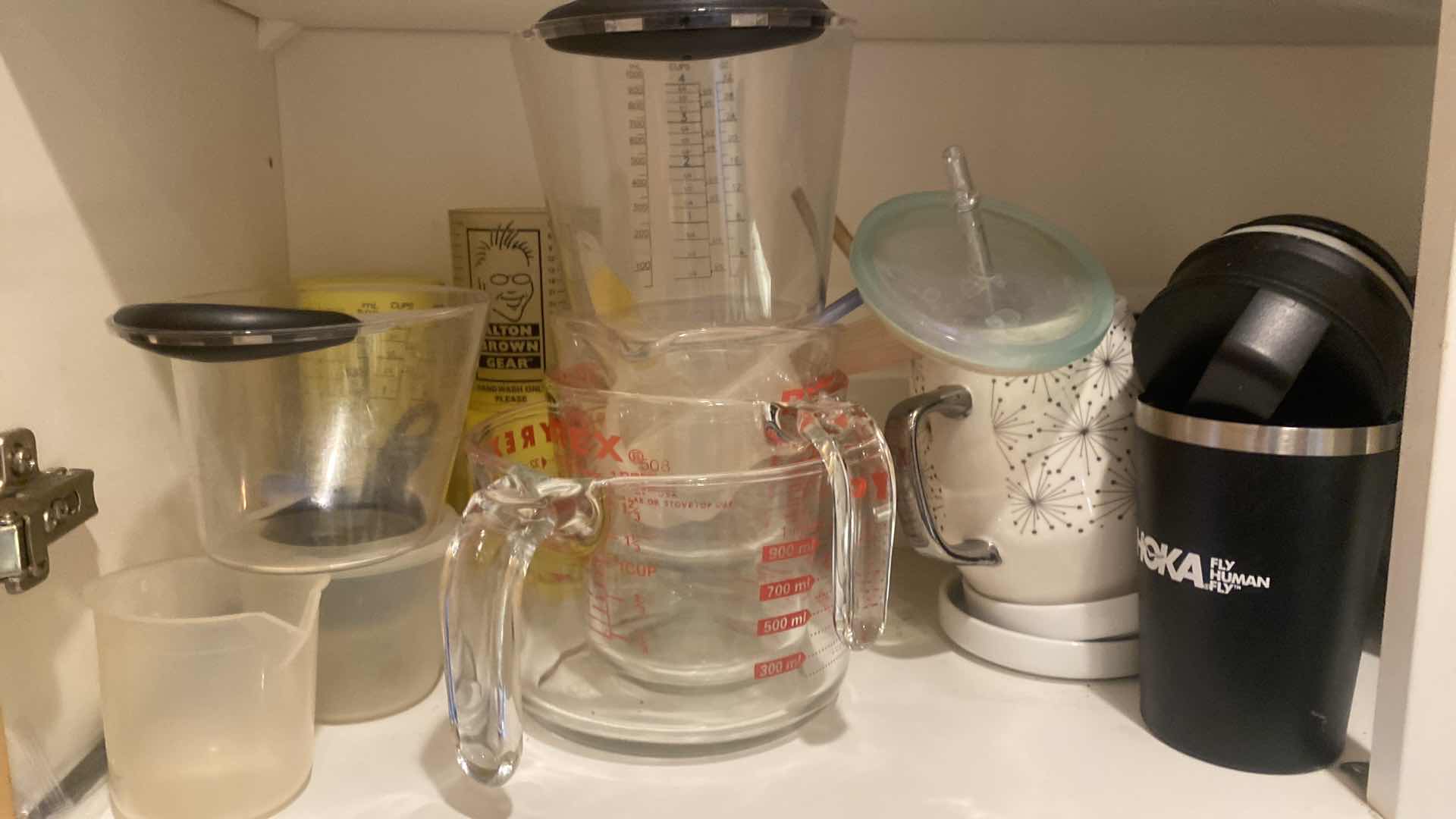 Photo 1 of CONTENTS OF KITCHEN CABINET - BAKEWARE & MEASURING CUPS