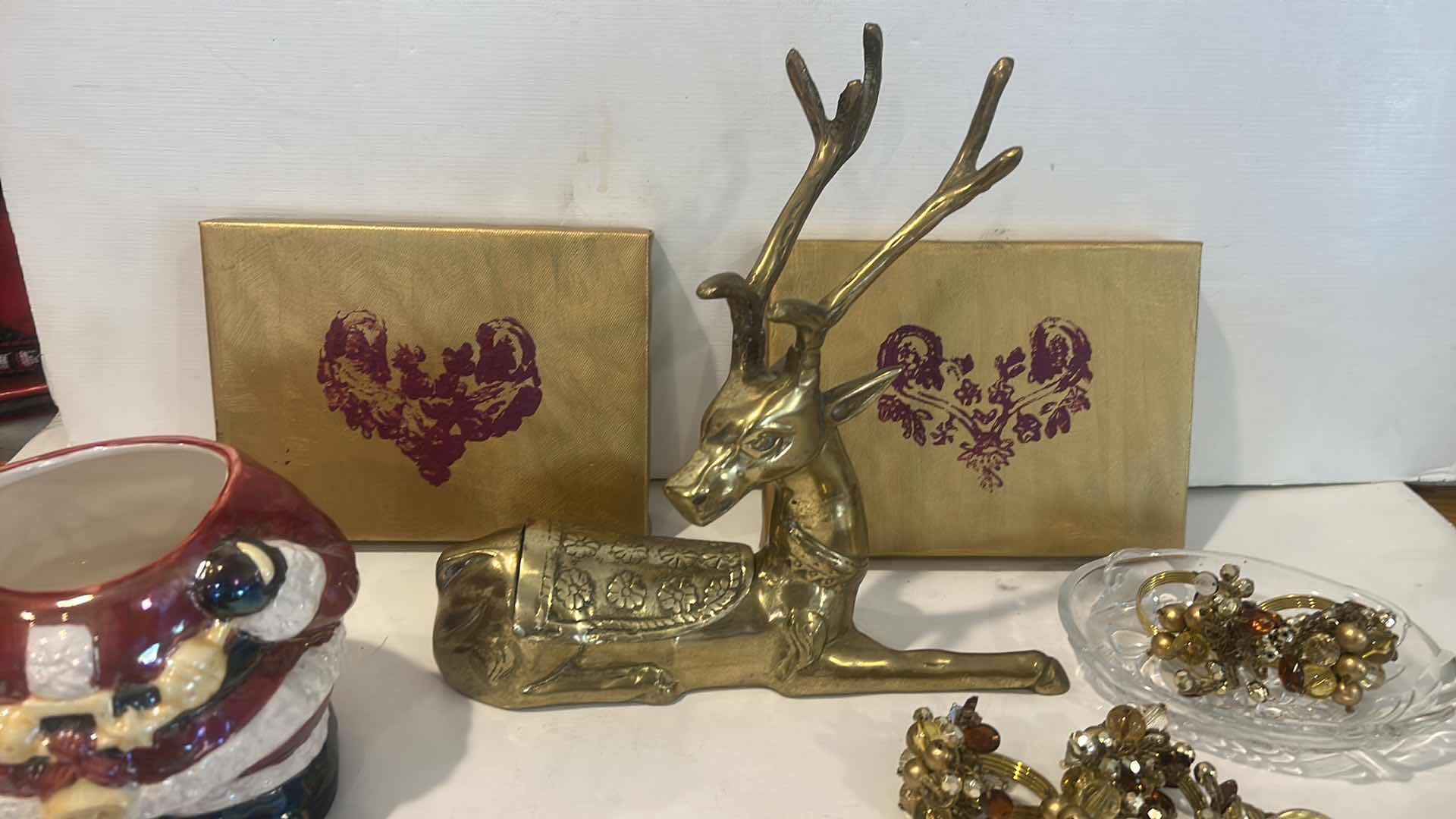 Photo 1 of CHRISTMAS DECOR /  LIDDED SANTA JAR, NAPKIN RINGS, BRASS REINDEER, ARTWORK & GLASS TRINKET DISH