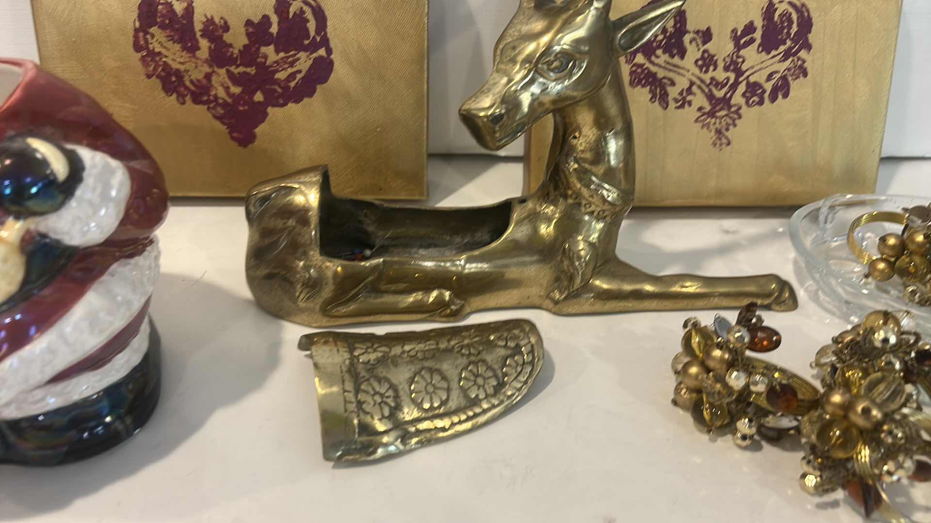 Photo 1 of CHRISTMAS DECOR /  LIDDED SANTA JAR, NAPKIN RINGS, BRASS REINDEER, ARTWORK & GLASS TRINKET DISH