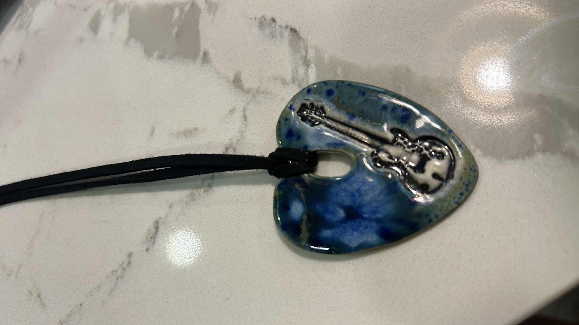 Photo 1 of MEN / WOMENS JEWELRY- FROM THE BRAND SURLY-RAMICS, HAND FORMED, HAND PAINTED BY ARTIST AMY DAVID ROTH, CERAMIC HEART WITH GUITAR MADE FROM EARTHENWARE CLAY, FIRED TWICE AND FINISHED WITH LEAD FREE FOOD SAFE GLAZES. EACH PIECE IS UNIQUE