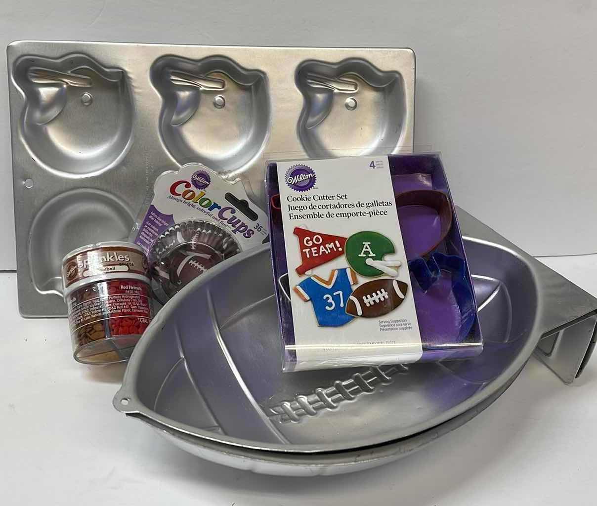 Photo 1 of NEW WILTON FOOTBALL PARTY CAKE PANS , CUPCAKE LINNERS , TOPPERS AND MORE - RETAIL PRICE $41.00