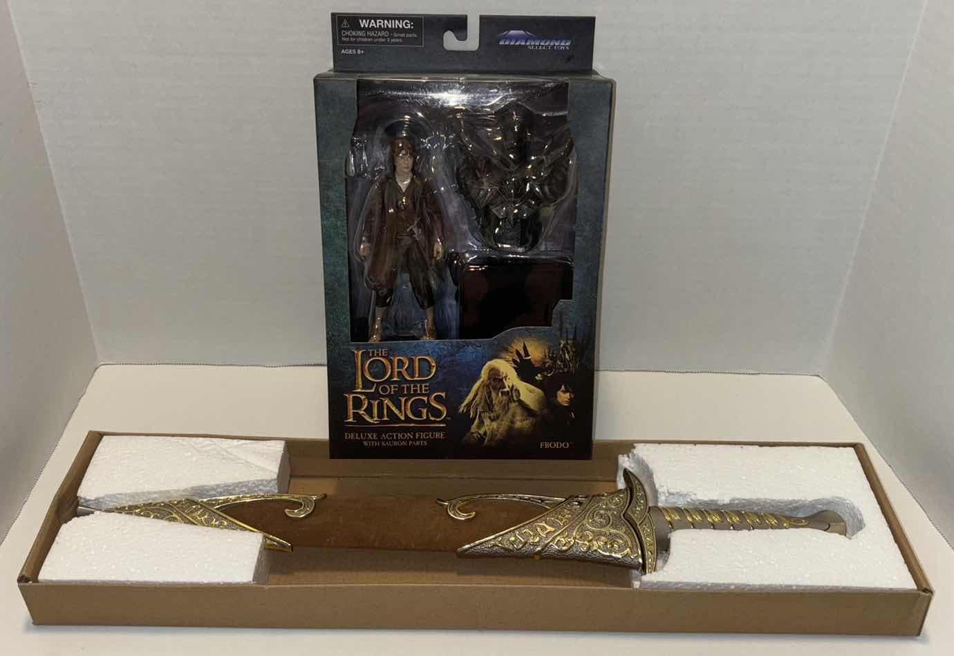 Photo 1 of NEW DIAMOND SELECT TOYS THE LORD OF THE RINGS DELUXE “FRODO” ACTION FIGURE & ACCESSORIES & NEW 20” LORD OF THE RINGS FRODO BAGGINS DART SWORD WITH BROWN VELVET SHEATH