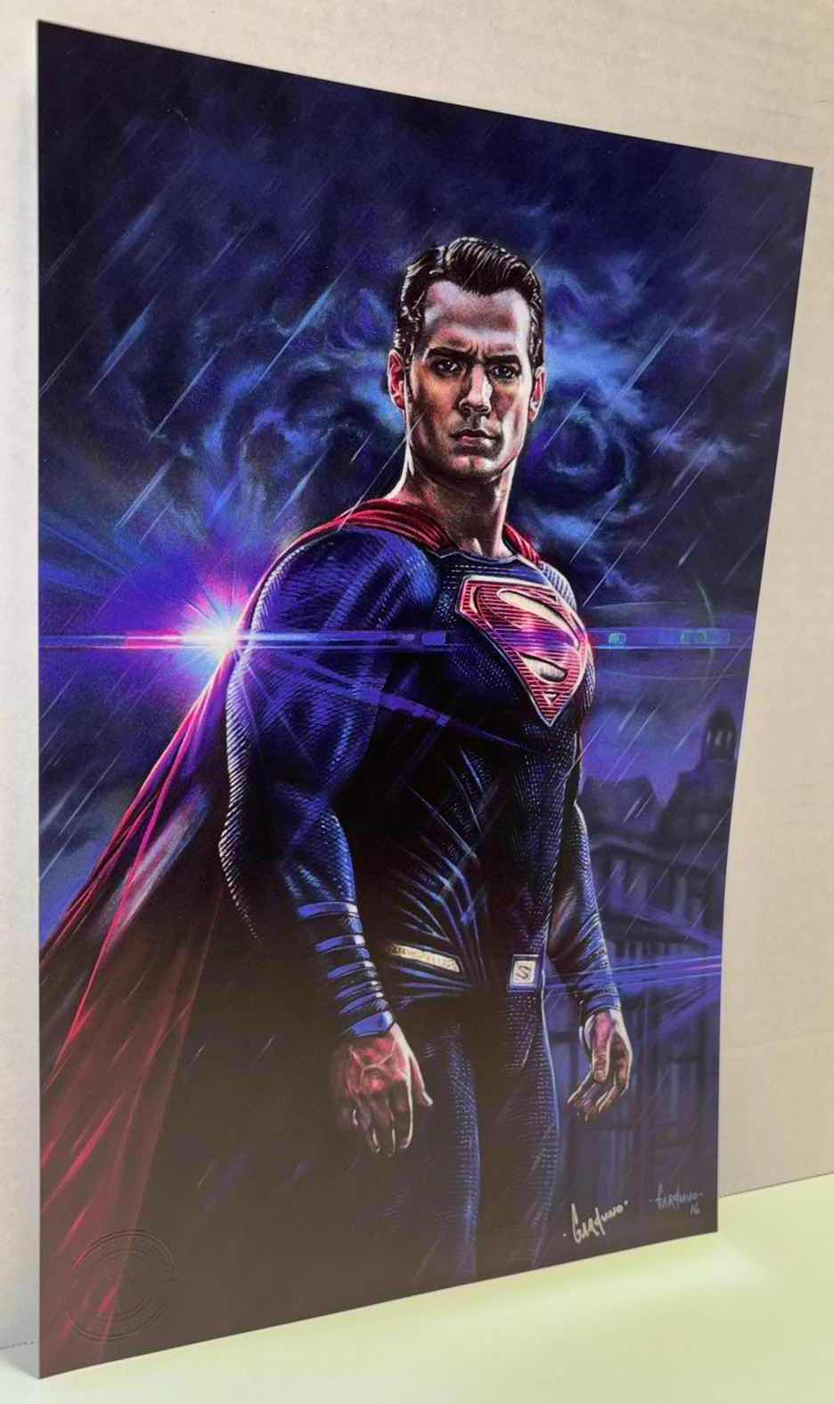 Photo 1 of VICTOR GARDUNO “MAN OF STEEL” 11” X 17” INFINITY GLOSS UNFRAMED PRINT W EMBOSSED SEAL, DIGITAL SIGNATURE & OFFICIAL SIGNATURE W COA INCLUDED, STORED IN A RIGID PRINT PROTECTOR SLEEVE