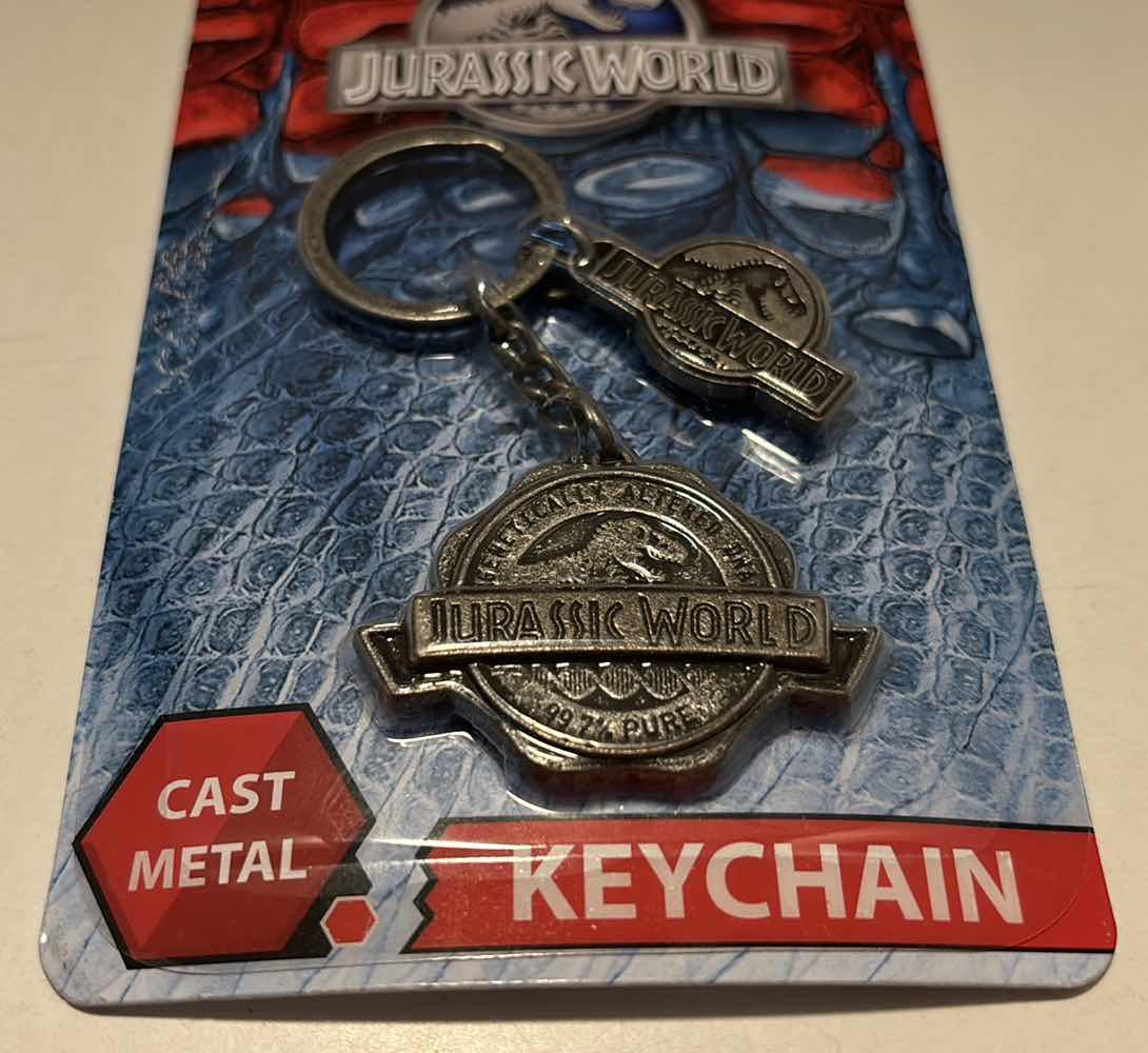 Photo 2 of NEW FACTORY ENTERTAINMENT JURASSIC WORLD CAST METAL KEYCHAIN (1)