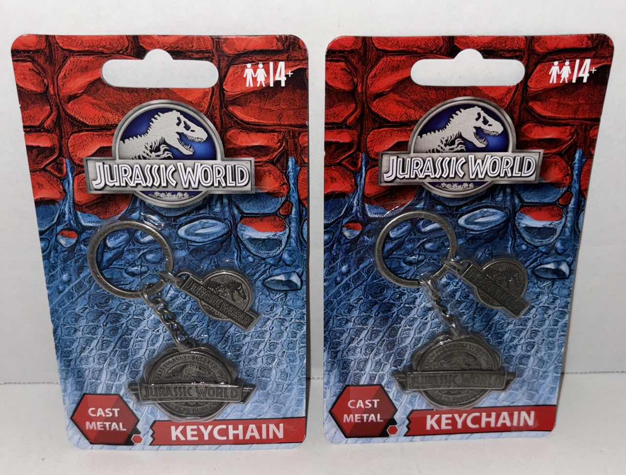 Photo 1 of NEW 2-PACK FACTORY ENTERTAINMENT JURASSIC WORLD CAST METAL KEYCHAIN
