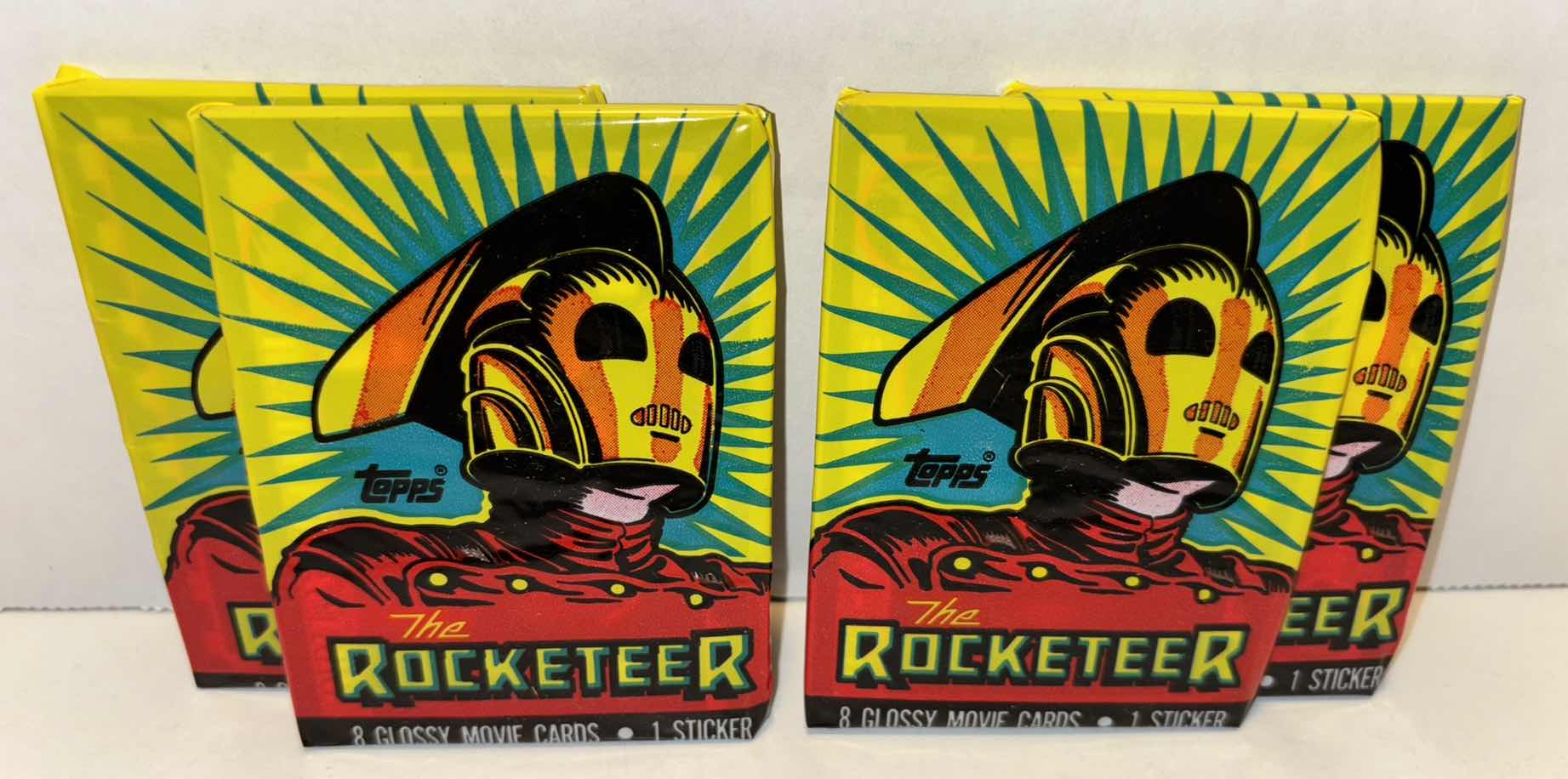 Photo 1 of NEW 4-PACK VINTAGE TOPPS 1991 COLLECTIBLE TRADING CARDS, 8 CT GLOSSY MOVIE CARDS W STICKER, “DELUXE THE ROCKETEER”