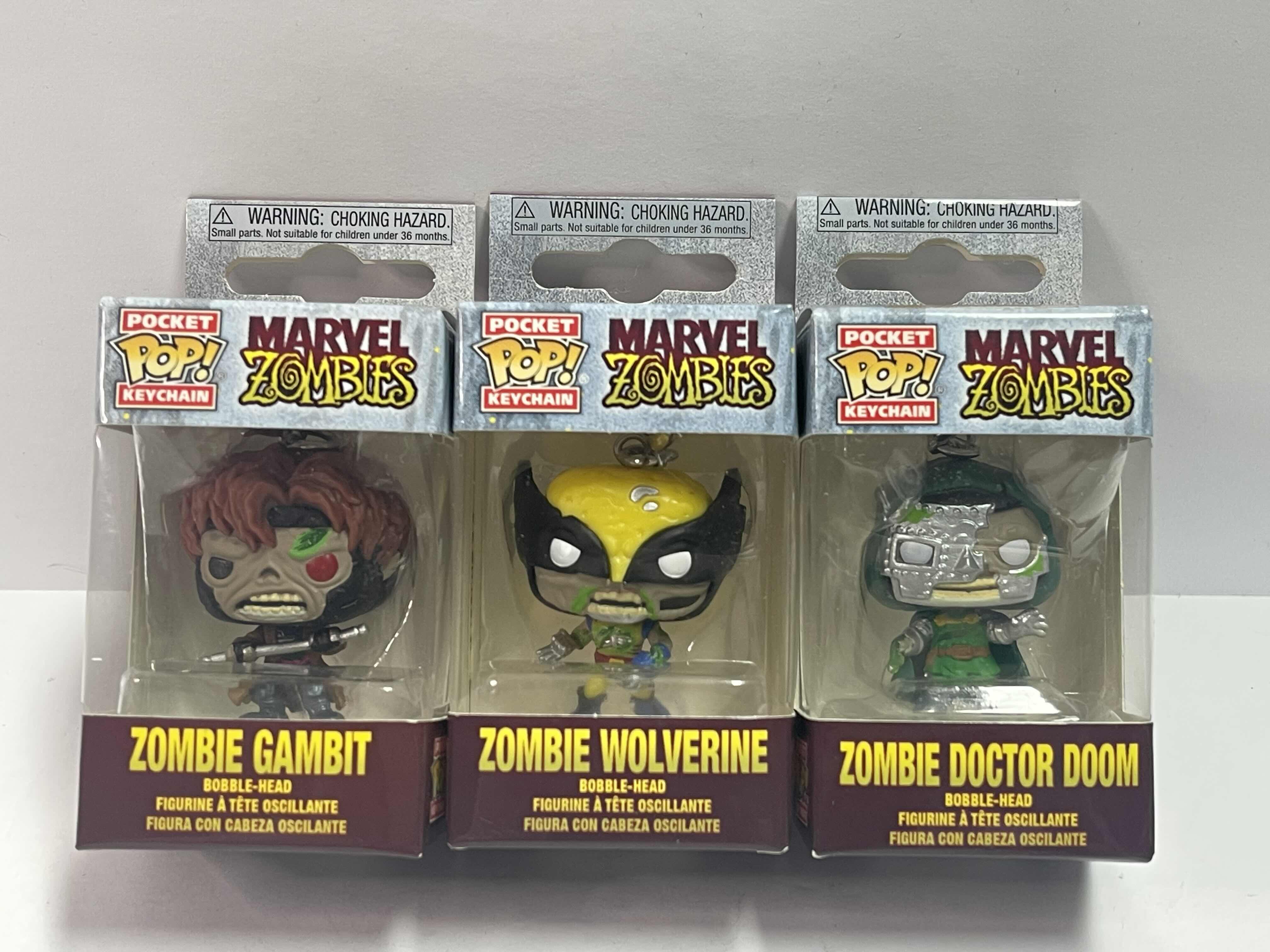 Photo 1 of NEW 3 POCKET POP KEYCHAINS “MARVEL ZOMBIES “ - ZOMBIE WOLVERINE , DR DOOM & GAMBIT - TOTAL RETAIL PRICE $ 32.00