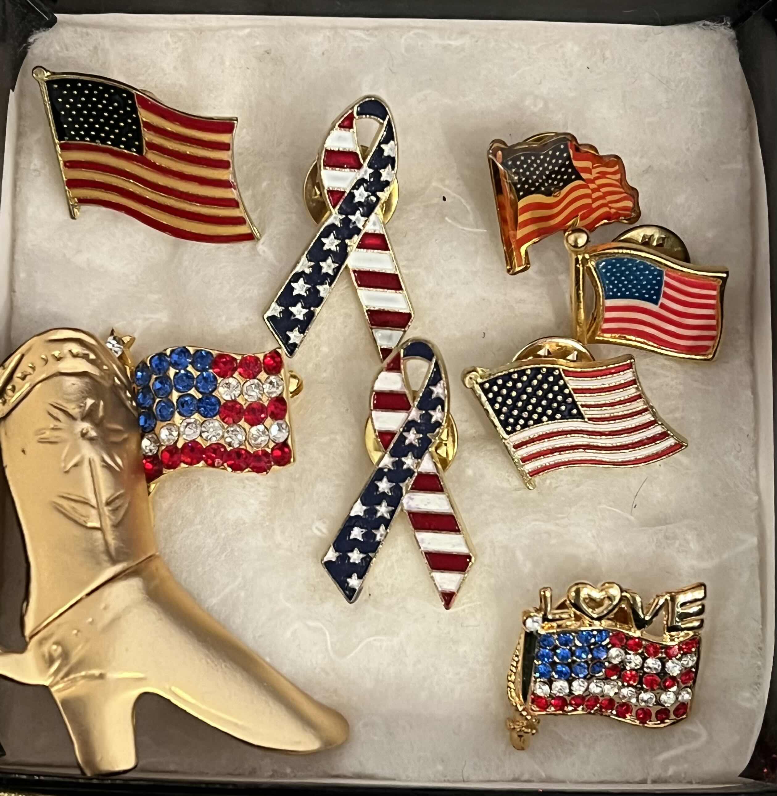 Photo 1 of AMERICAN FLAG PINS AND COWBOY BOOT BROACH.