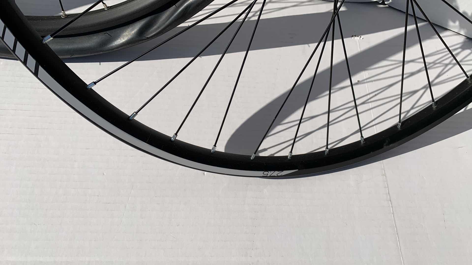 Photo 1 of 2-BICYCLE RIMS AND 1 TIRE. 27.5"D FOR A ROAD BIKE.