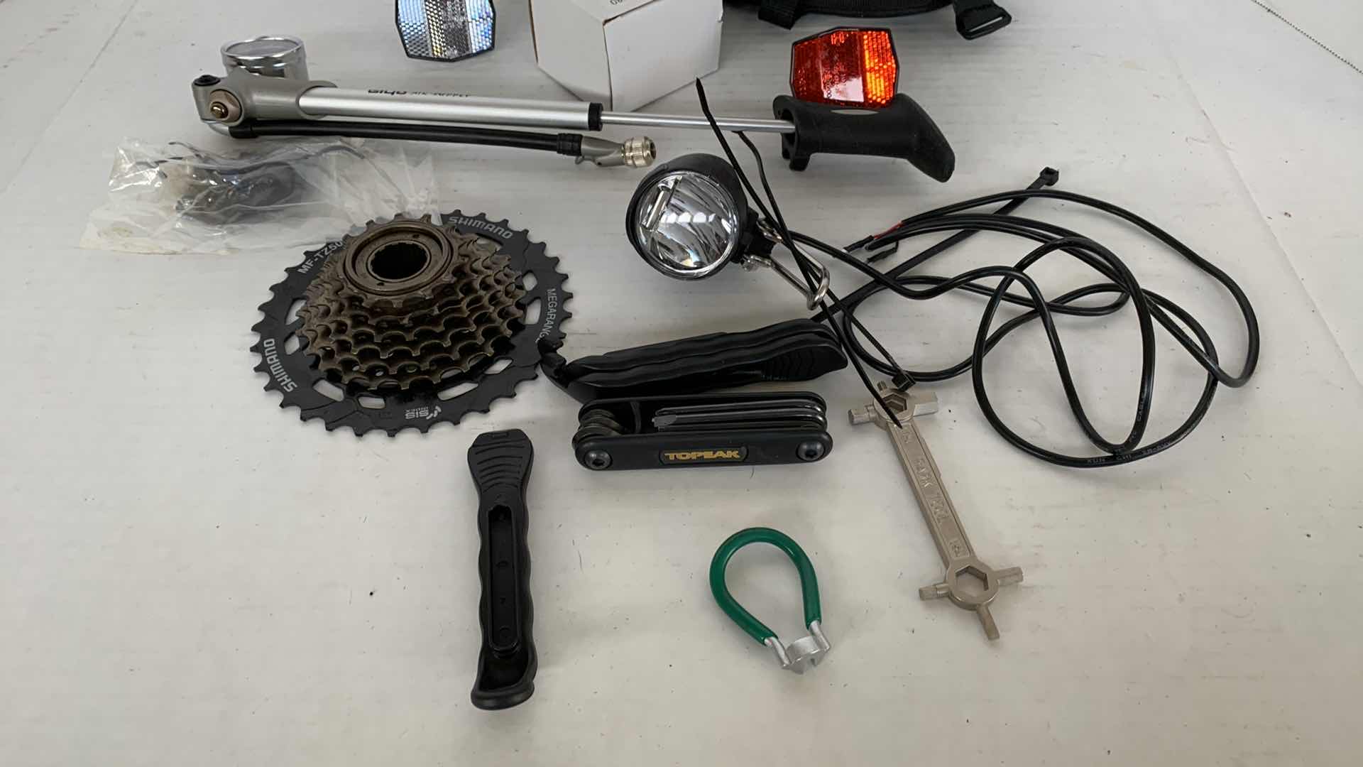 Photo 3 of ASSORTED BICYCLE PARTS AND ACCESSORIES. SPROCKET, REFLECTORS, ON PORTABLE BIKE AIR TIRE PUMP. VARIOUS TOOLS.