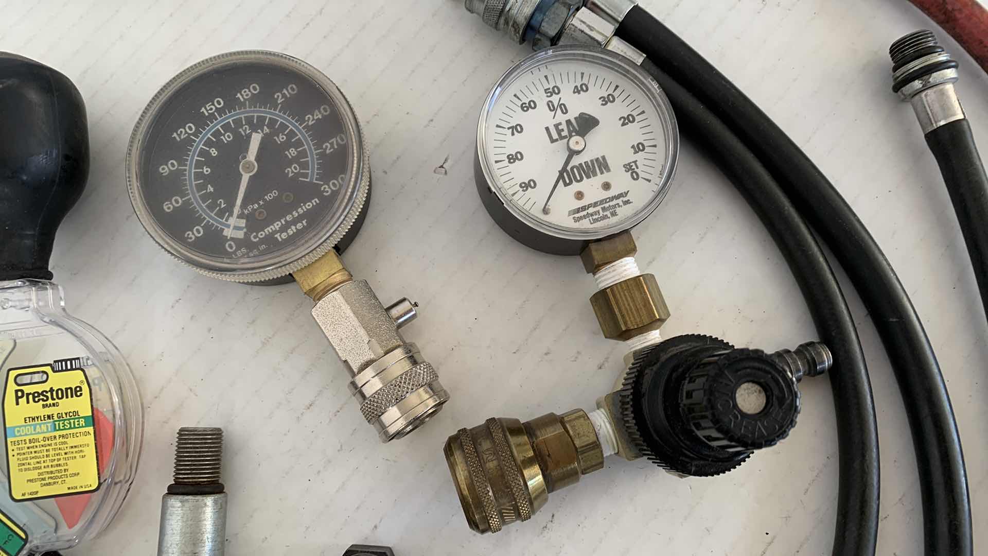Photo 1 of AUTOPARTS-ENGINE REPAIR TOOLS INCLUDING A PISTON COMPRESSION GAUGE