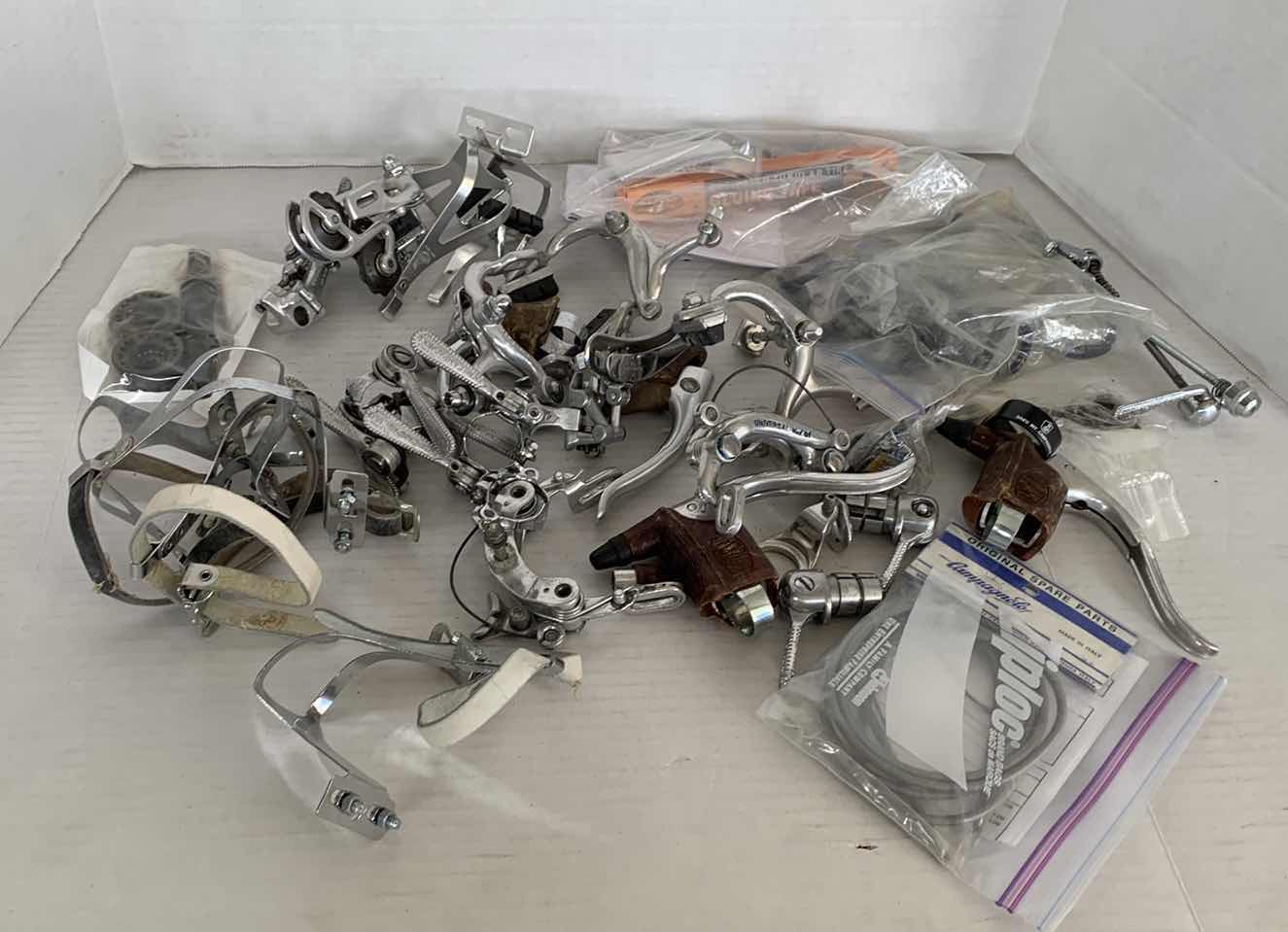 Photo 1 of BICYCLE BRAKES, FOOT STIRRUPS, AND OTHER ITEMS. ROAD BICYCLE ACCESSORIES.