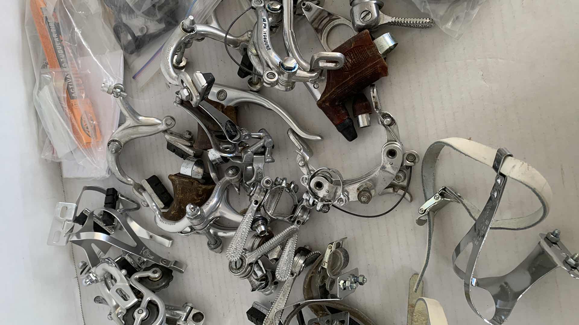 Photo 1 of BICYCLE BRAKES, FOOT STIRRUPS, AND OTHER ITEMS. ROAD BICYCLE ACCESSORIES.