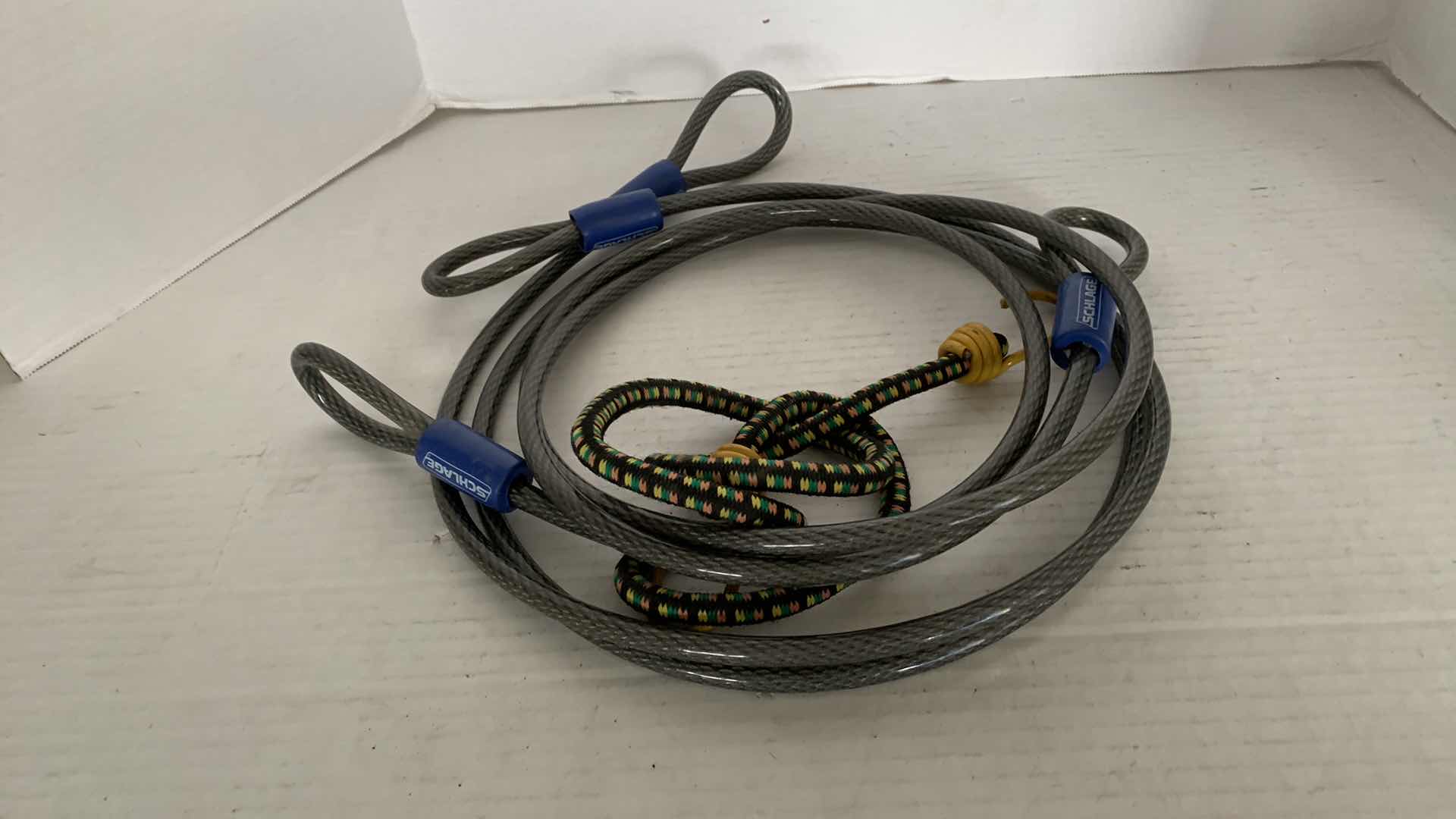 Photo 1 of 2-6.5 FOOT SCHLAGE HEAVY DUTY SECURITY CABLES AND A BUNGEE CORD