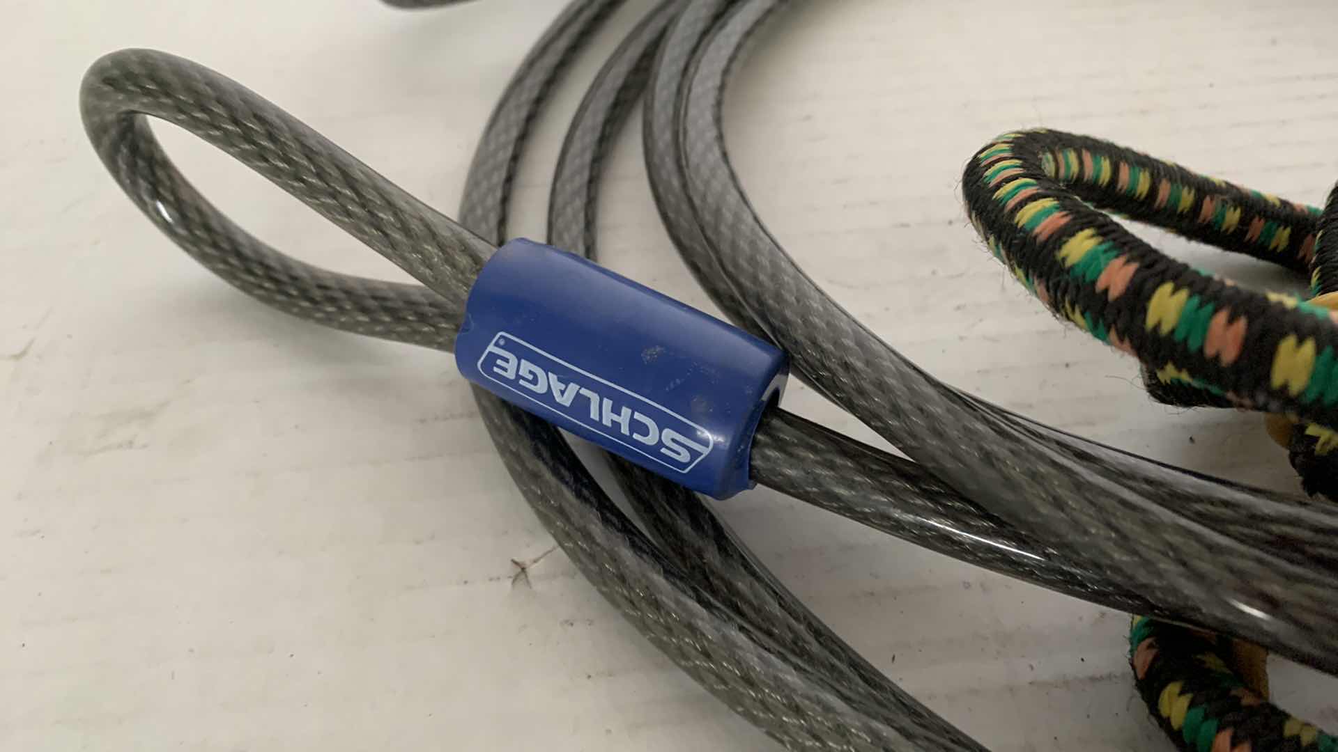 Photo 1 of 2-6.5 FOOT SCHLAGE HEAVY DUTY SECURITY CABLES AND A BUNGEE CORD