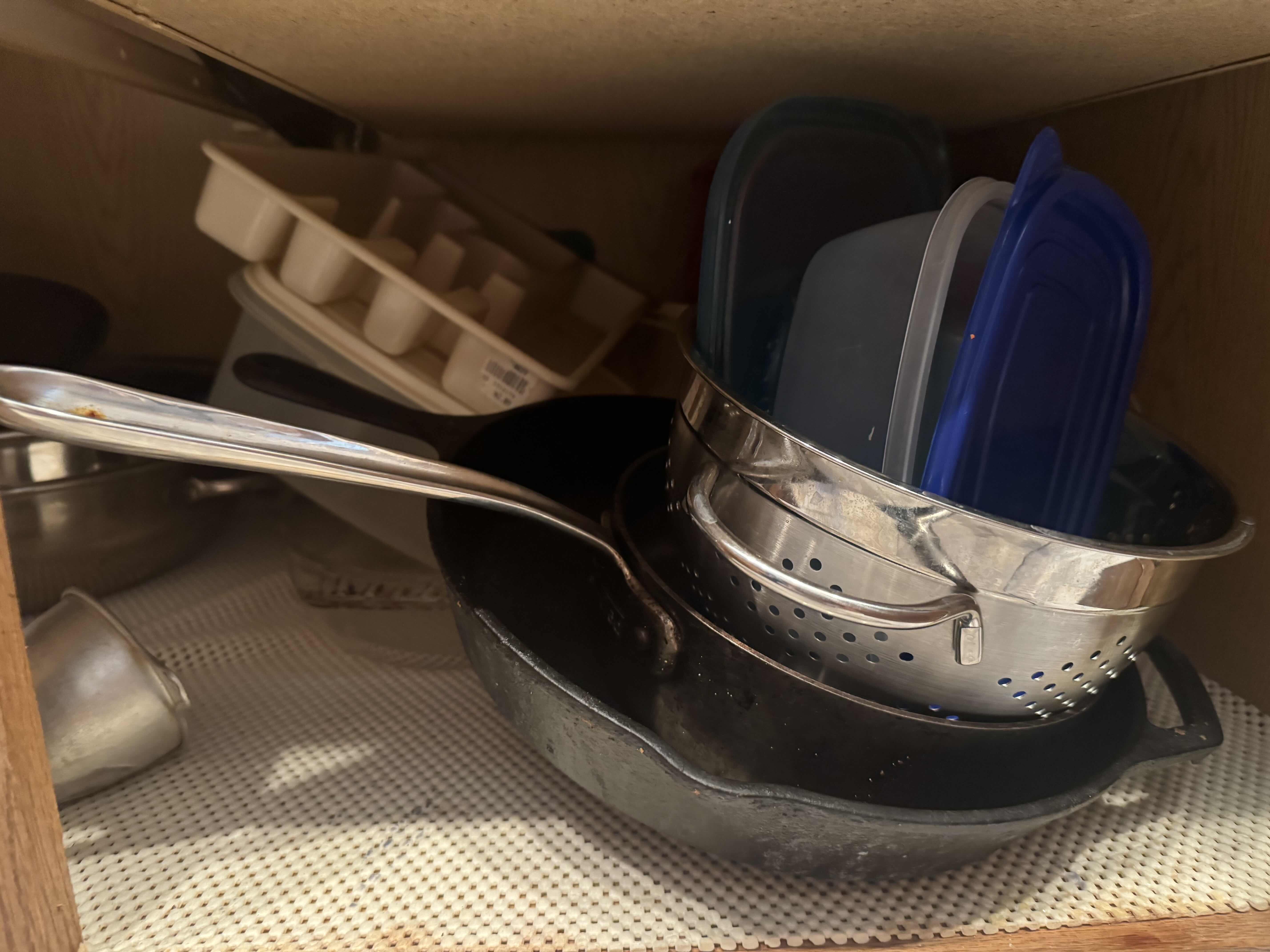 Photo 1 of CONTENTS OF KITCHEN CABINET. MIXING AND SERVING BOWLS AND DISHES. POTS AND PANS, AND BAKING DISHES.