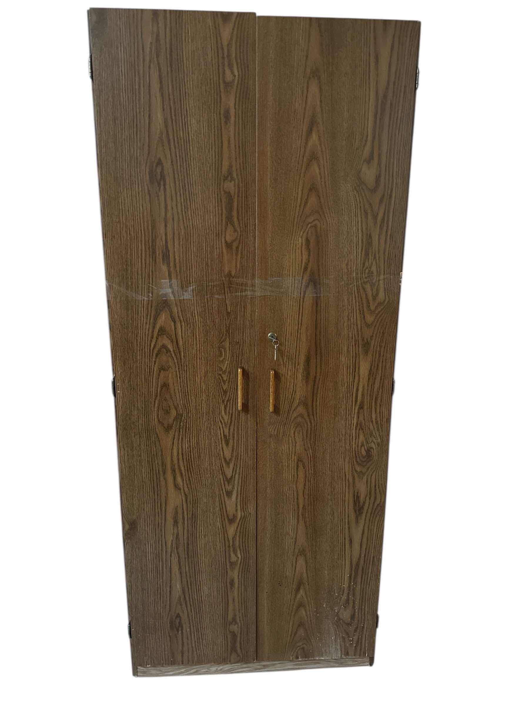 Photo 1 of PRESSED WOOD SHELF WITH DOORS 29“ x 16“ H 71”