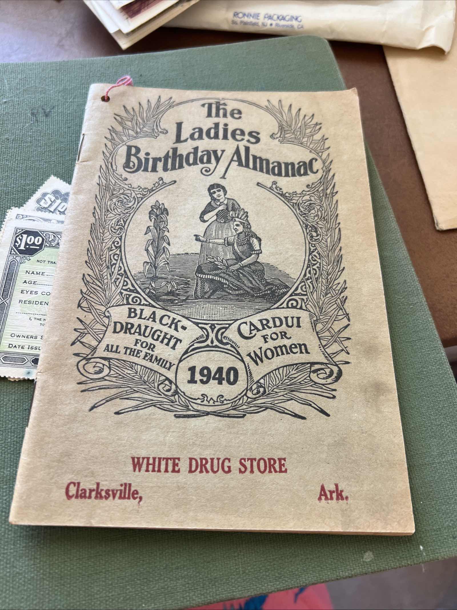 Photo 1 of ANTIQUE BOOK AND ALMANAC -  1940 LADIES BIRTHDAY ALMANAC “WHITE DRUG STORE”, USPS POSTAGE STAMP REFERENCE BOOK AND OLD POSTCARDS