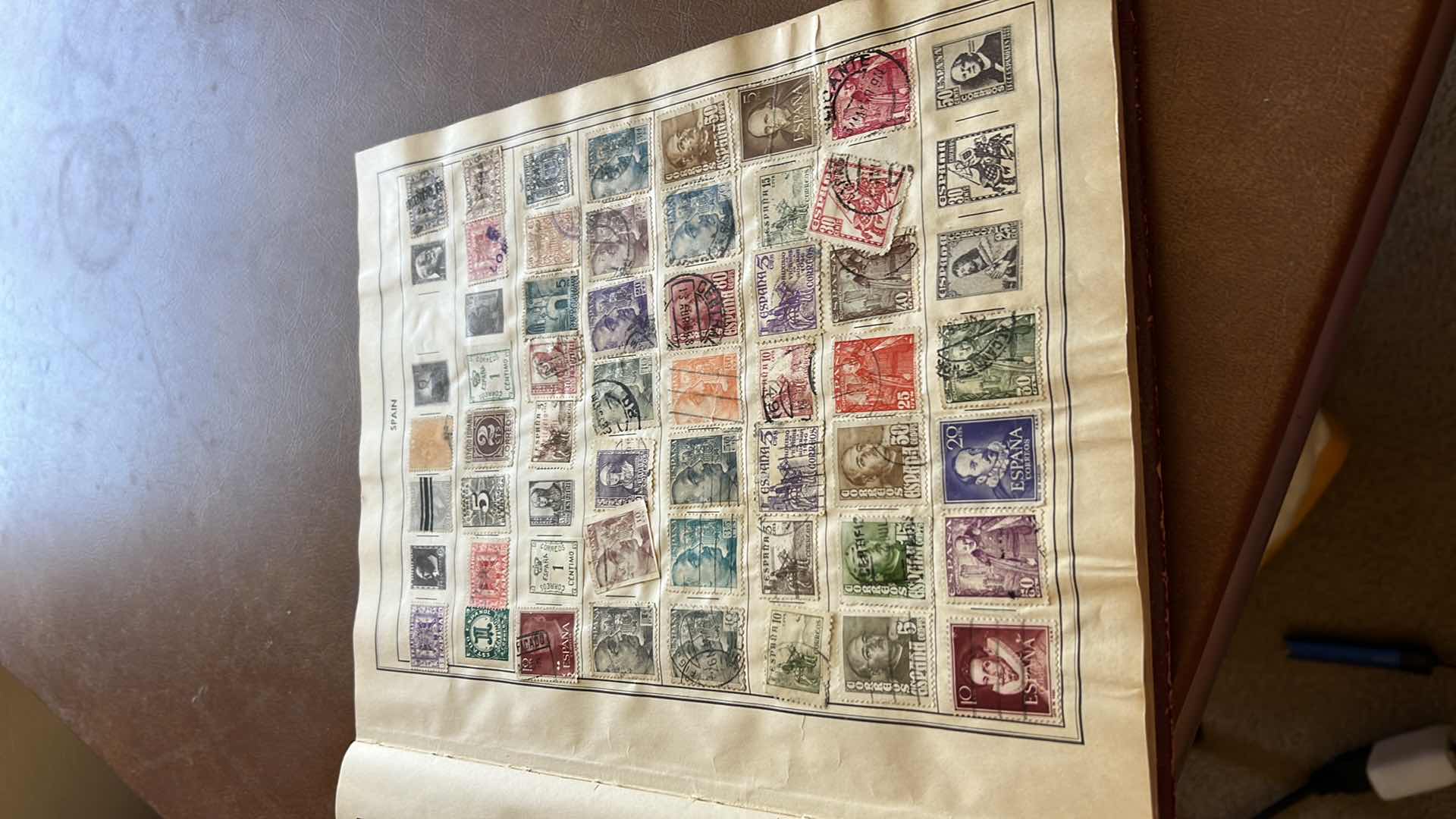 Photo 1 of “THE TRAVELERS ALBUM OF POSTAGE STAMPS OF THE WORLD”- VINTAGE - AND CONTENTS. THE BOOK IS FAIRLY FULL.  MOST STAMPS ARE CANCELLED. PLUS ADDITIONAL” STAMPS OF THE WORLD” BINDER WITH ADDITIONAL STAMPS - NO RETURNS