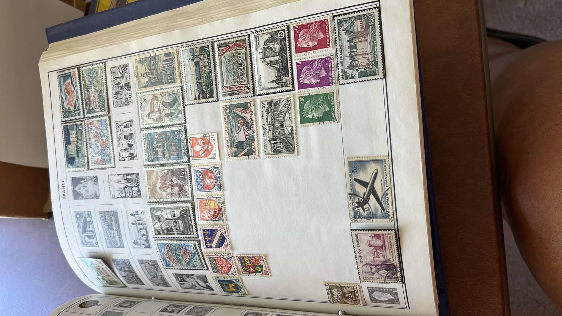 Photo 1 of “THE TRAVELERS ALBUM OF POSTAGE STAMPS OF THE WORLD”- VINTAGE - AND CONTENTS. THE BOOK IS FAIRLY FULL.  MOST STAMPS ARE CANCELLED. PLUS ADDITIONAL” STAMPS OF THE WORLD” BINDER WITH ADDITIONAL STAMPS - NO RETURNS