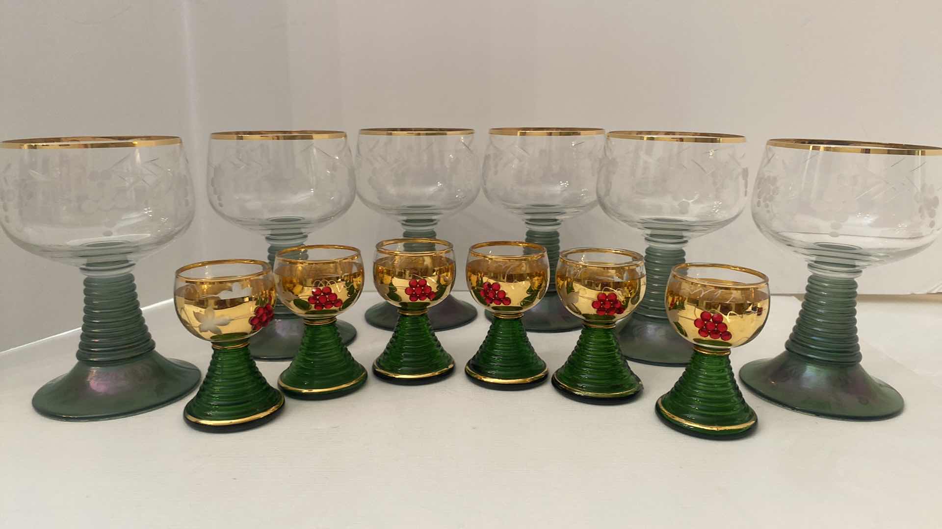 Photo 1 of VINTAGE GERMAN ROEMER GREEN AND GOLD RIMMED WINE GLASSES AND GOLD JEWELED SHOT GLASSES