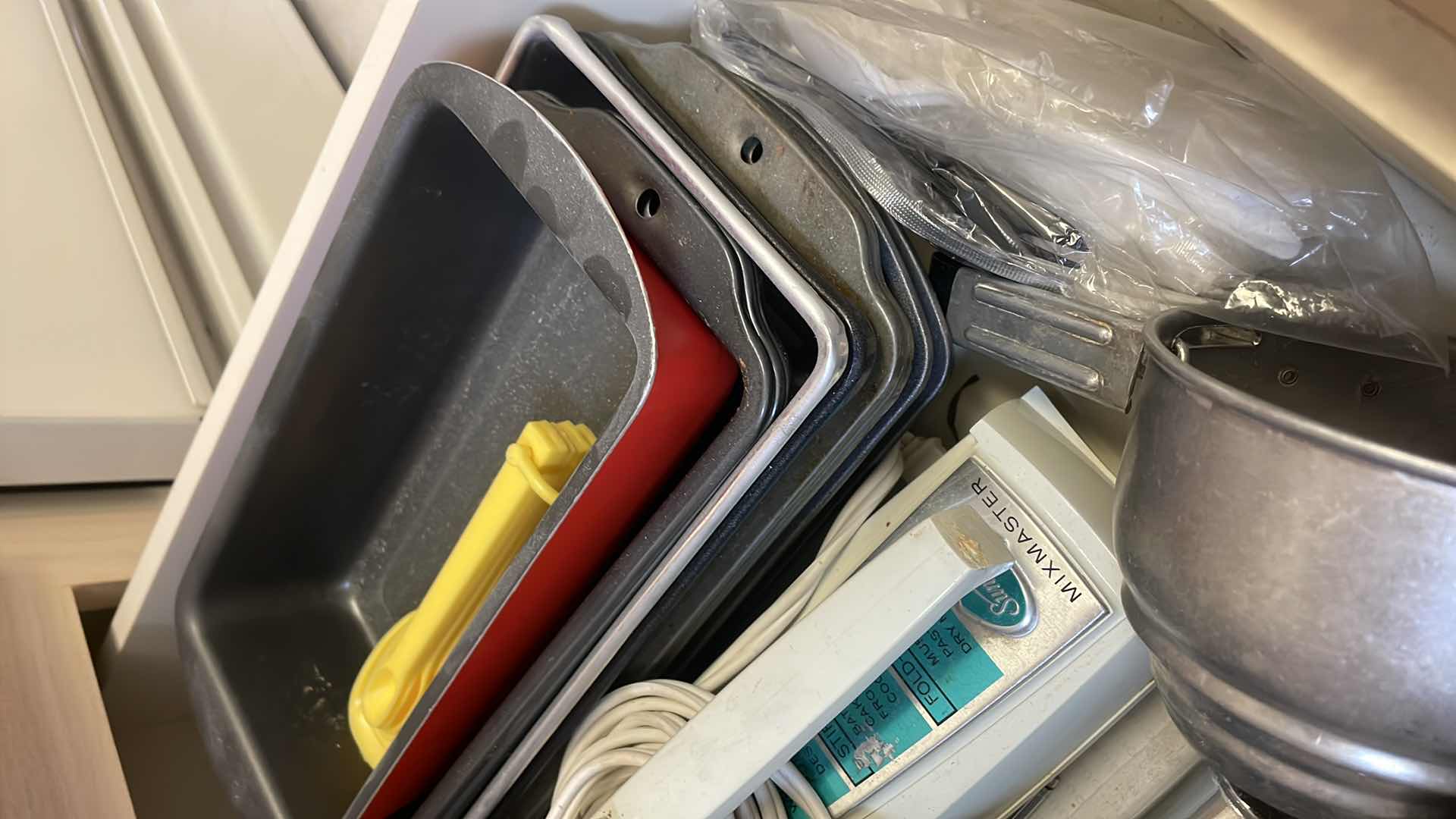 Photo 2 of CONTENTS OF KITCHEN DRAWER-BAKEWARE, HAND MIXER, UTENSILS