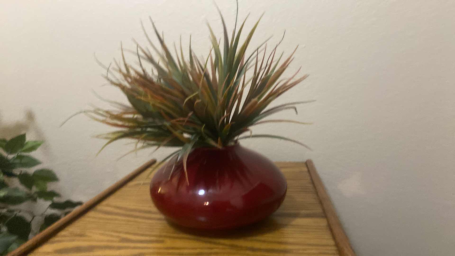 Photo 1 of RED CERAMIC VASE WITH FAUX PLANT OVERALL 9” x 14”