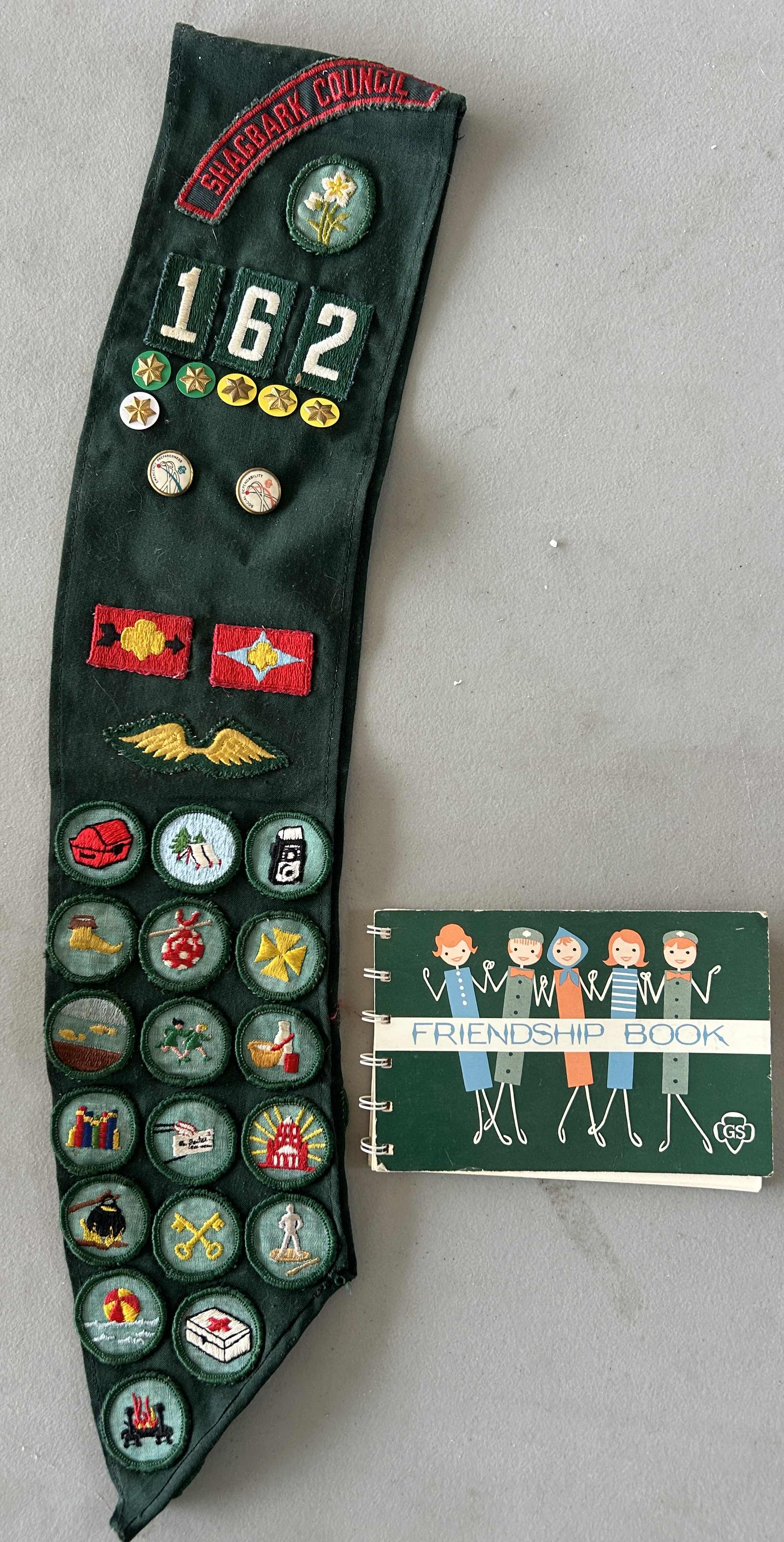 Photo 1 of VINTAGE GIRLSCOUT SASH, BADGES AND BOOK