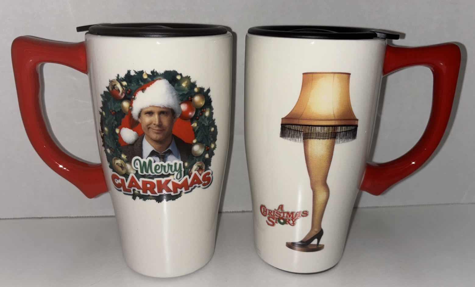 Photo 1 of NEW 2-PACK SPOONIQUES 18 OZ CHRISTMAS THEME CERAMIC TRAVEL MUG W/HANDLE, “MERRY CLARKMAS” & “A CHRISTMAS STORY LEG LAMP”