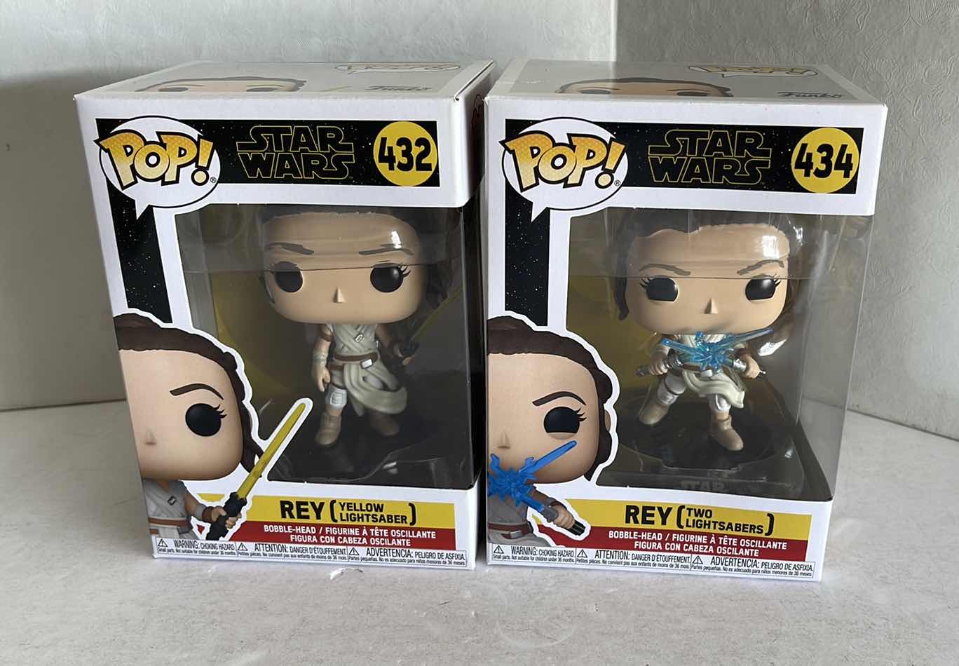 Photo 1 of NIB FUNKO POP STAR WARS REY #432 YELLOW LIGHTSABER & REY #434 TWO LIGHTSABERS MSRP $20