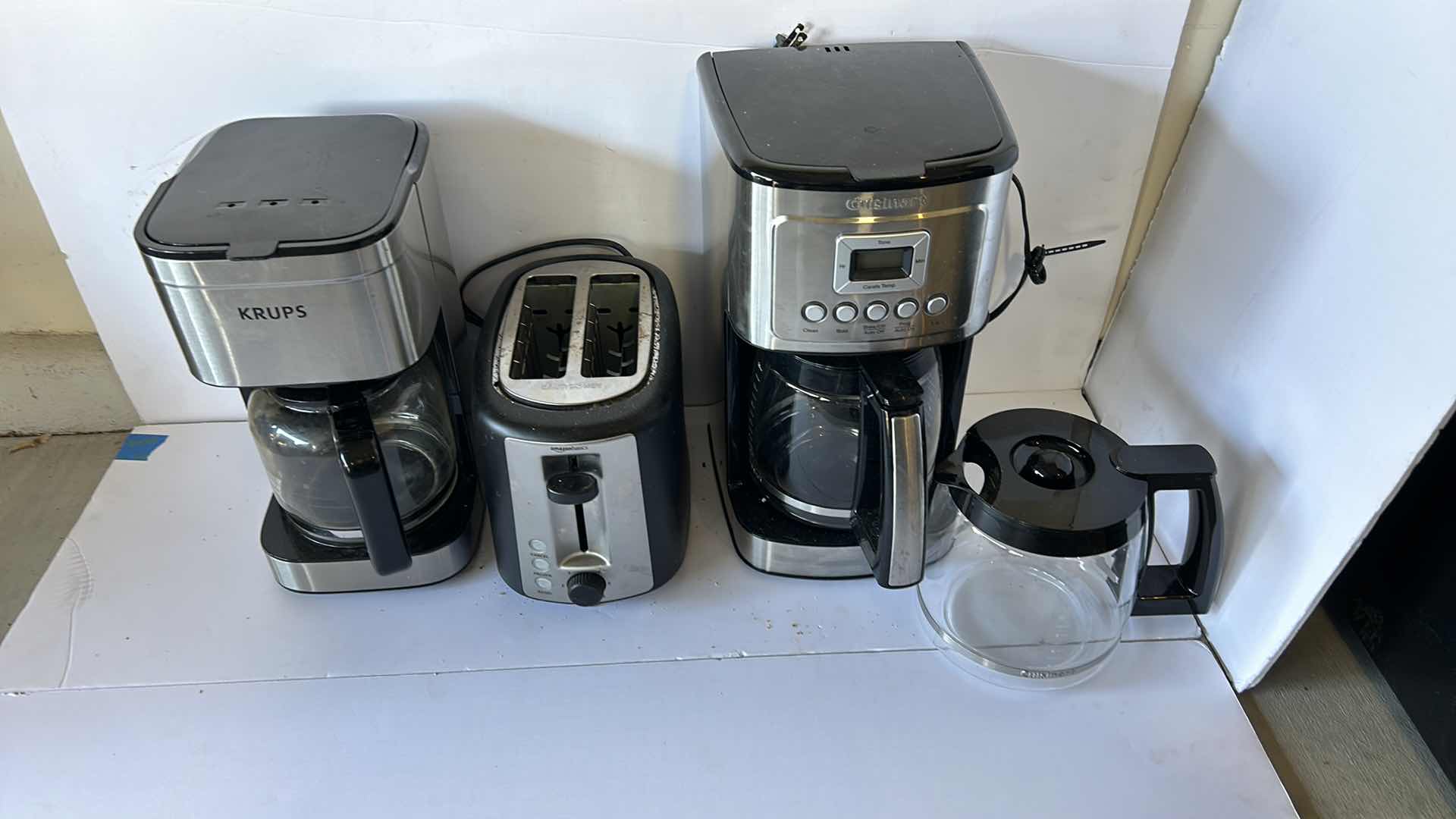 Photo 6 of HOUSEHOLD APPLIANCES. TWO COFFEE MAKERS, AN EXTRA COFFEE POT, AND A TOASTER.