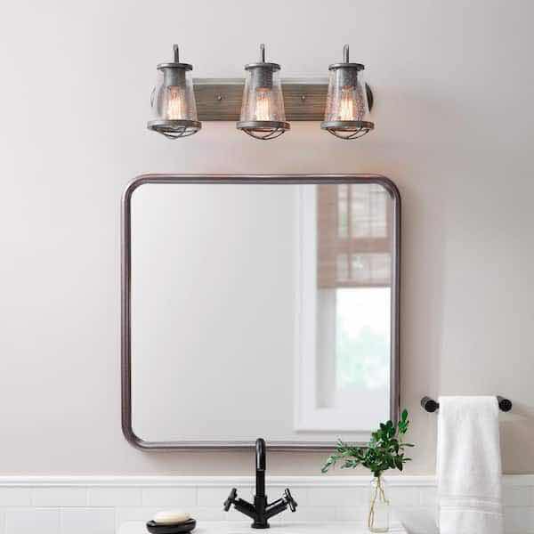 Photo 2 of HOME DECORATORS COLLECTION GEORGINA 3 LIGHT INDUSTRIAL RUSTIC VANITY FIXTURE W CLEAR SEEDED GLASS SHADES MODEL HB2626-322 24” X 9.75”