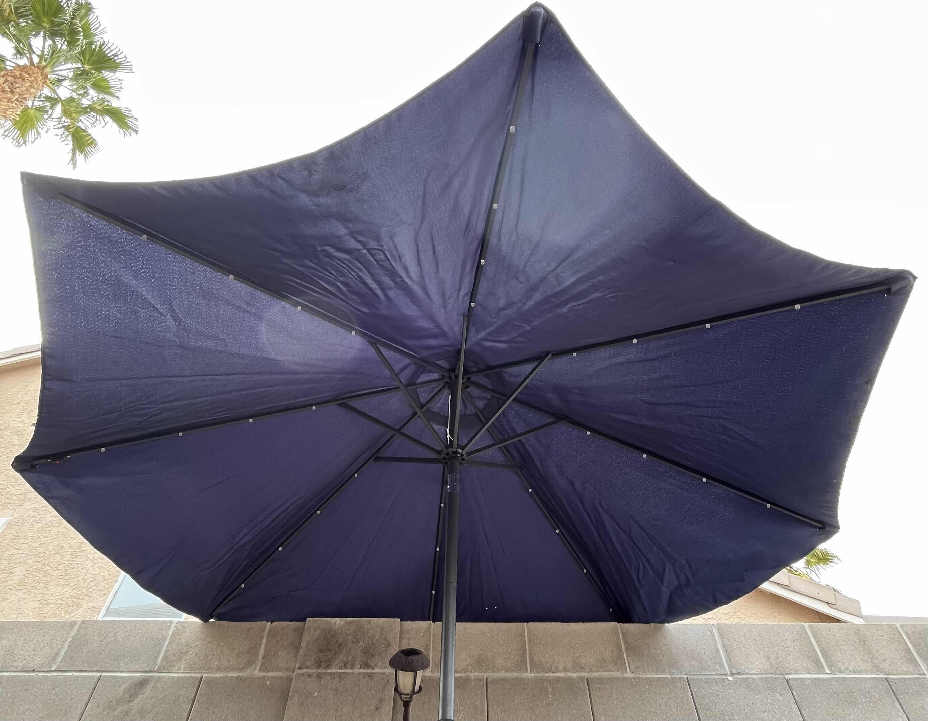 Photo 2 of DARK BLUE PATIO UMBRELLA W ROLLING UMBRELLA STAND 116” X 110”