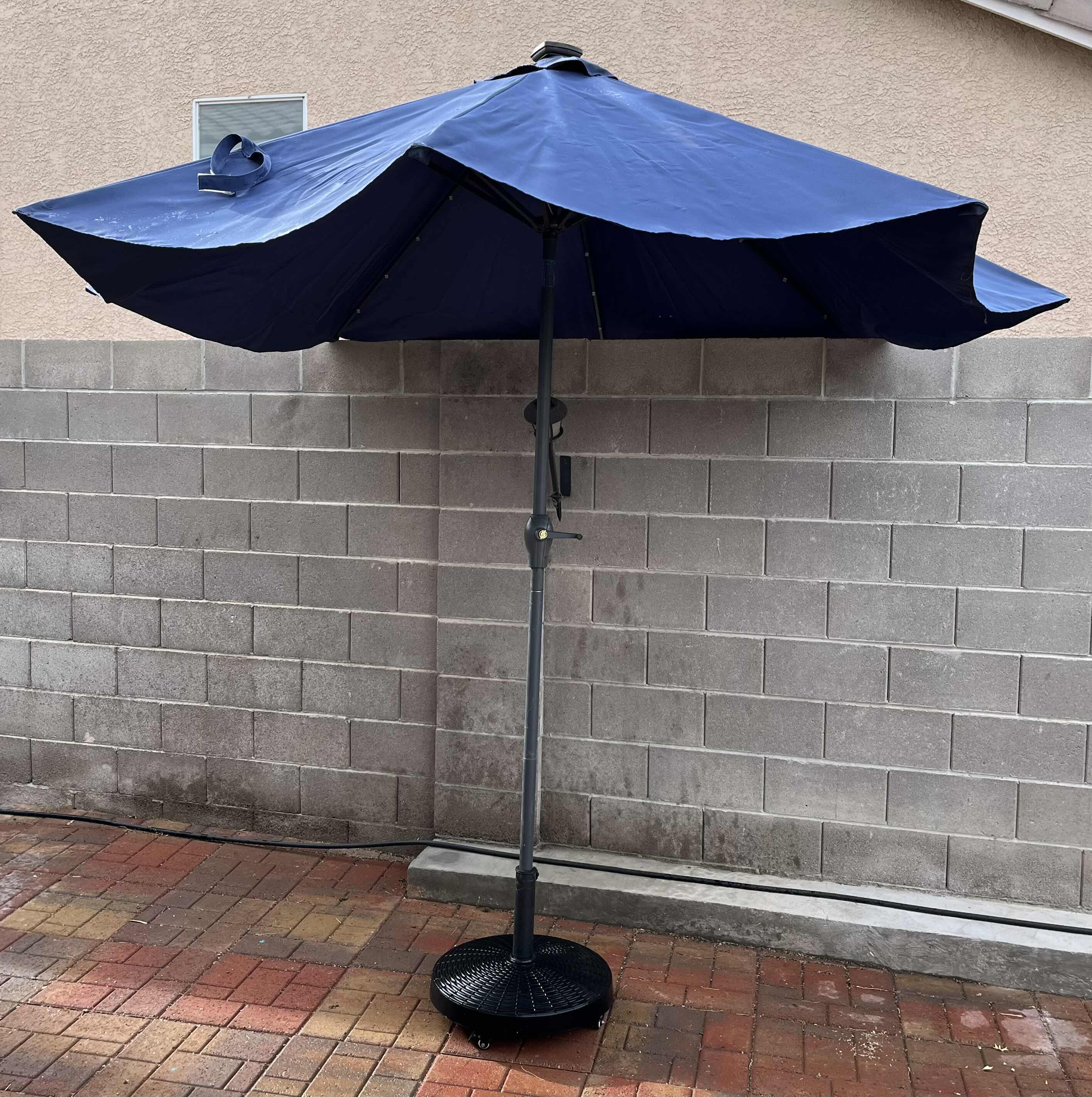 Photo 1 of DARK BLUE PATIO UMBRELLA W ROLLING UMBRELLA STAND 116” X 110”