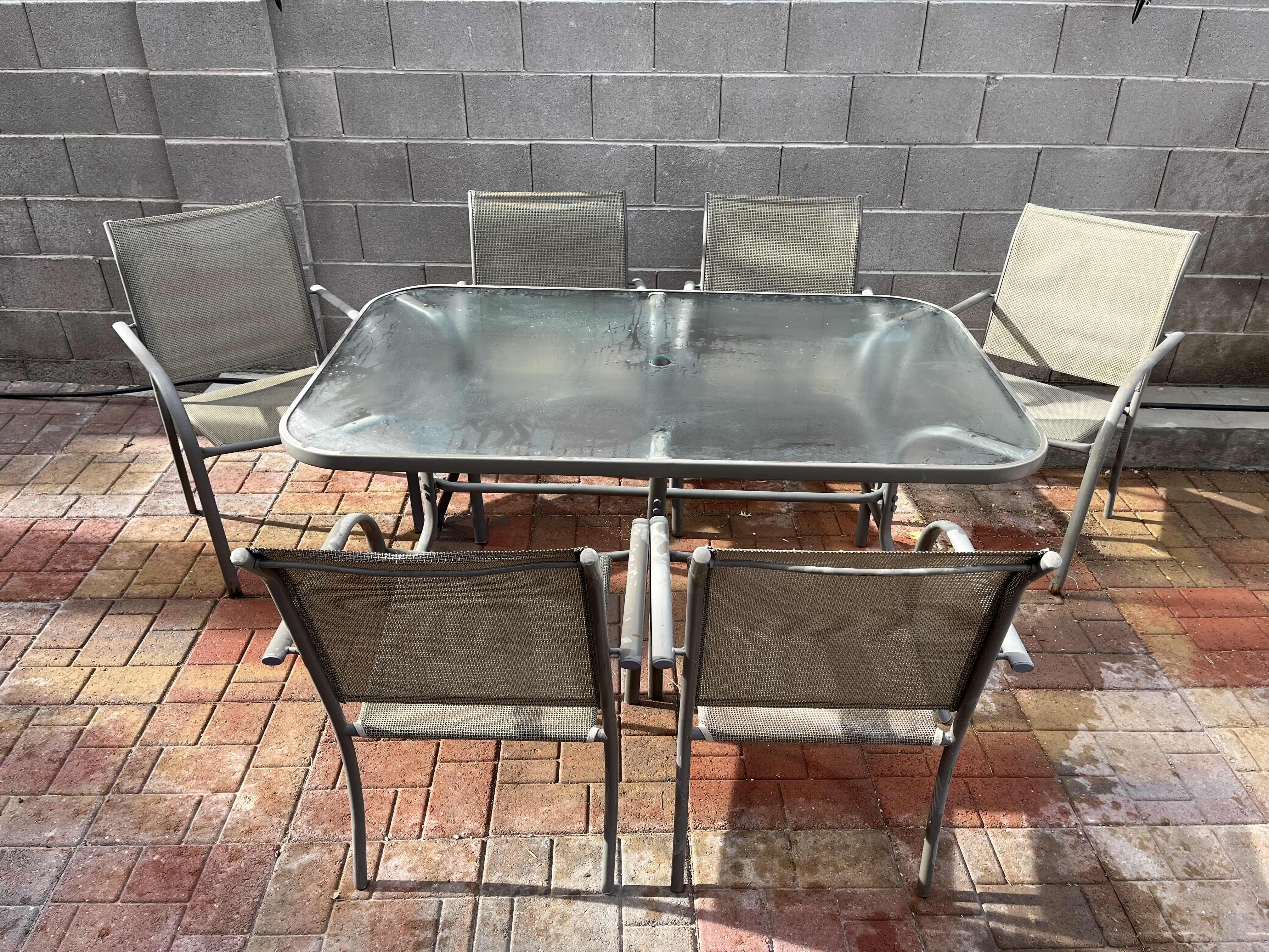 Photo 1 of PATIO GLASS TOP TABLE 60” X 38” H28.5” W MESH CHAIRS (6)