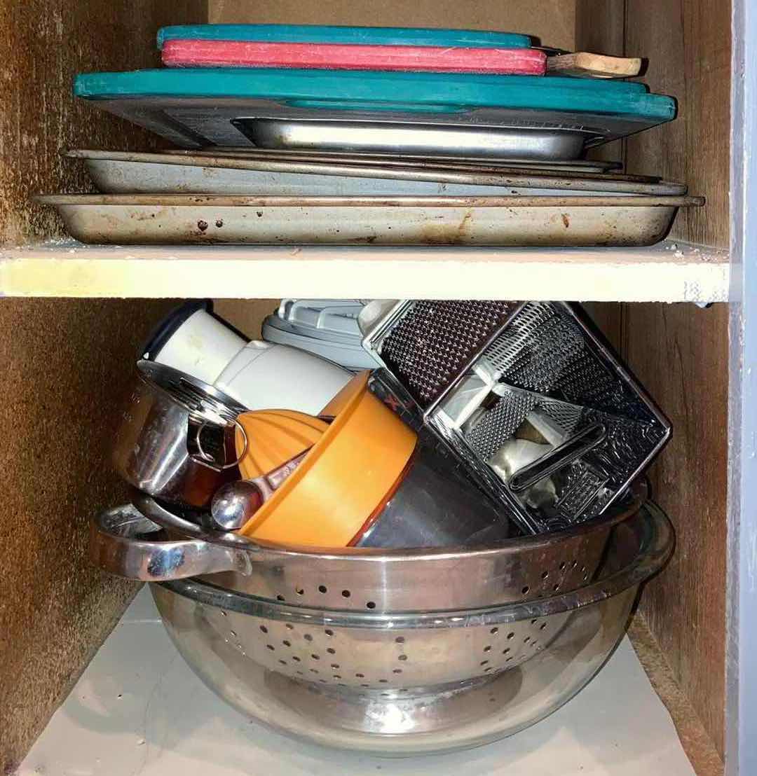 Photo 1 of CONTENTS OF CABINET- PLASTIC CUTTING BOARDS, BAKING PANS, STRAINERS, & KITCHEN ACCESSORIES