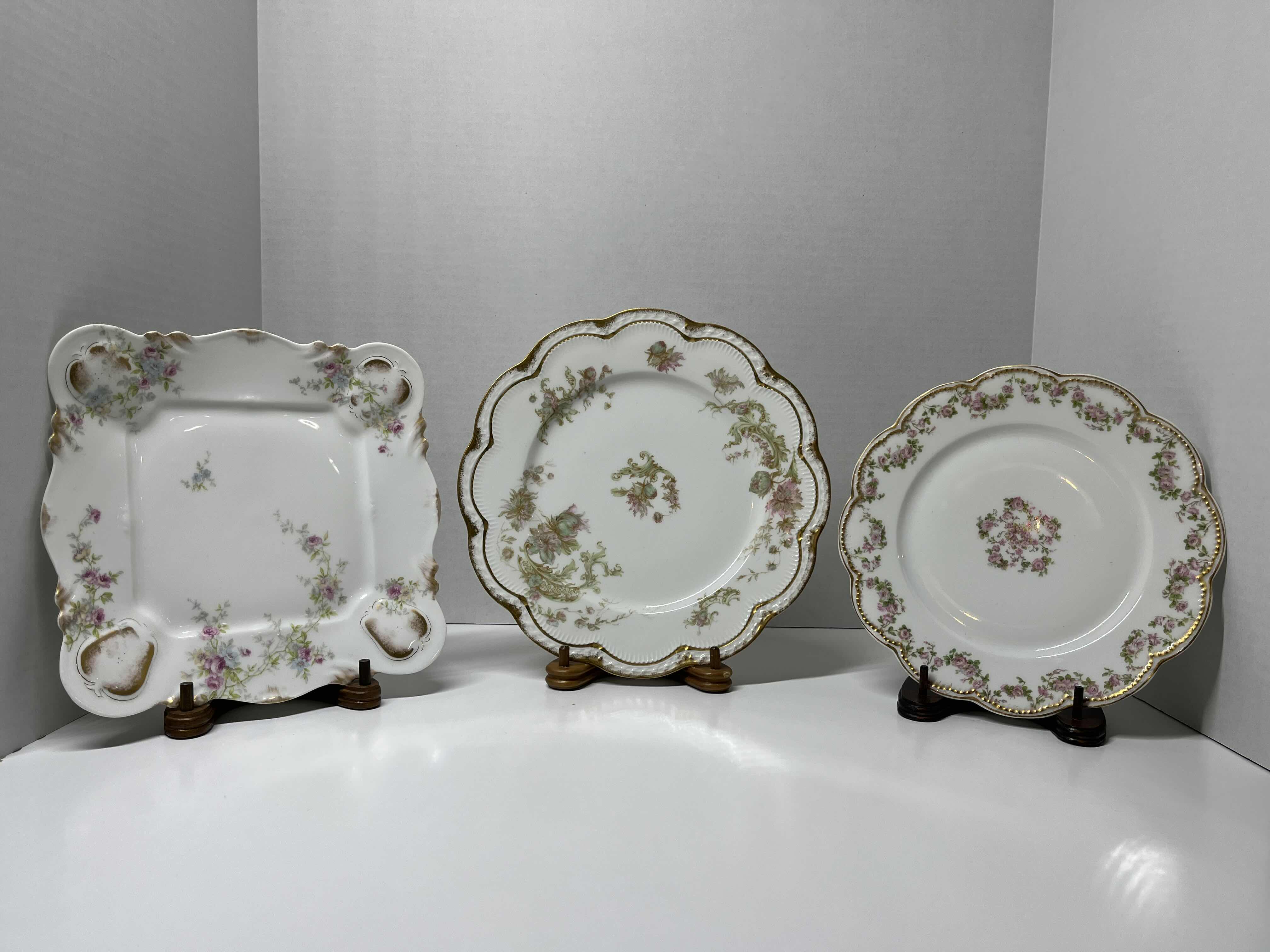 Photo 1 of ANTIQUE THEODORE HAVILAND LIMOGES FRANCE PINK, GREEN & GOLD EMBOSSED FLORAL DESIGN FINE CHINA PLATE SET (3) W WOOD DISPLAY STANDS (3)