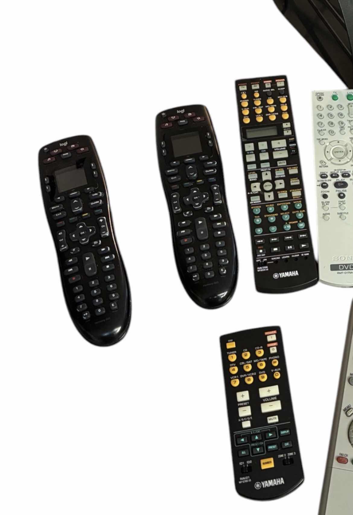 Photo 1 of LOGI HARMONY 665 UNIVERSAL REMOTES & VARIOUS BRAND REMOTES W BLACK METAL REMOTE CADDY