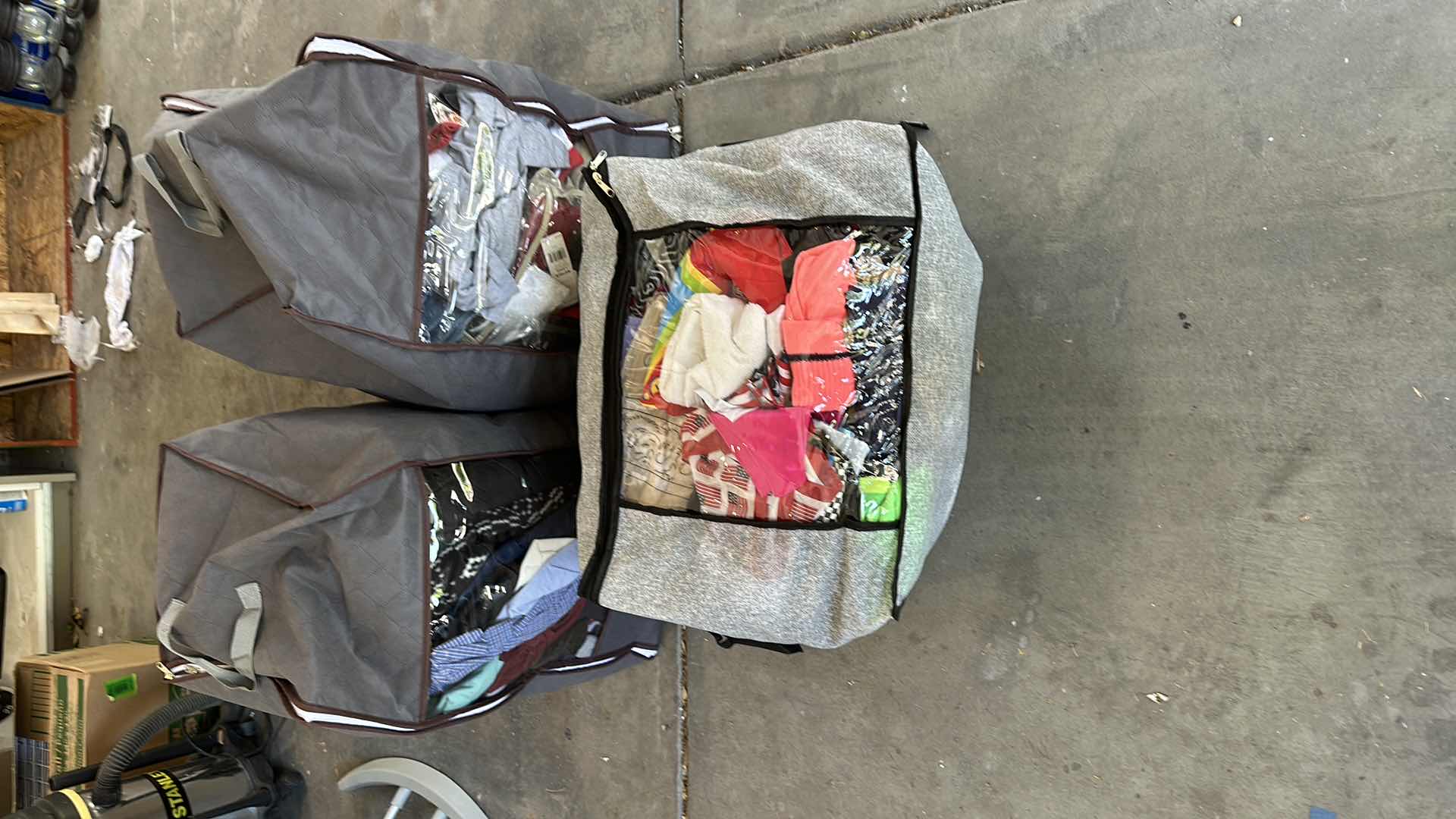 Photo 1 of THREE BAGS OF CLOTHES
