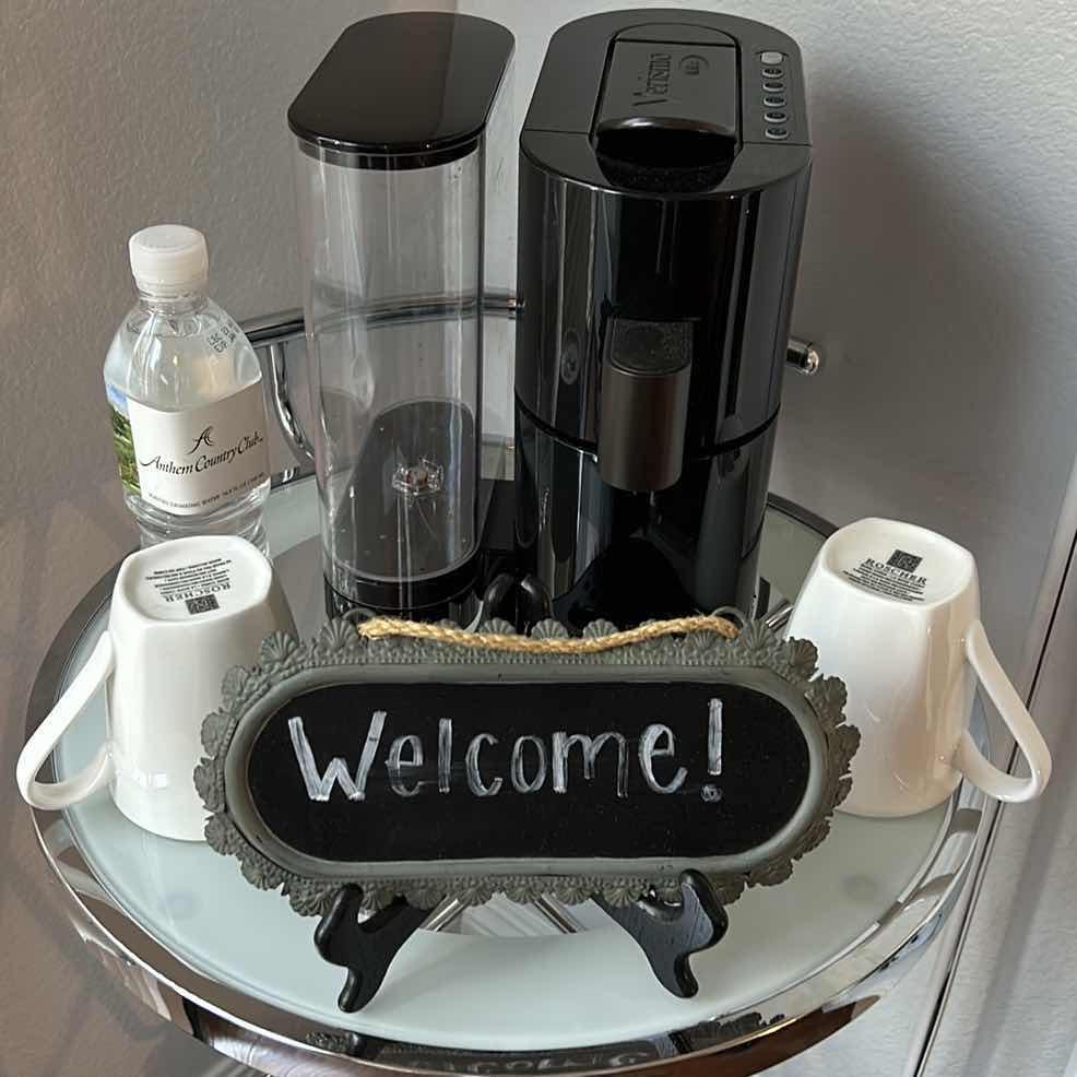 Photo 1 of COFFEE STATION - VERISMO COFFEE MAKER . WELCOME SIGN. TWO BONECHINA COFFEE MUGS BY ROCHERE & ANTHEM COUNTRY CLUB BOTTLED WATER.