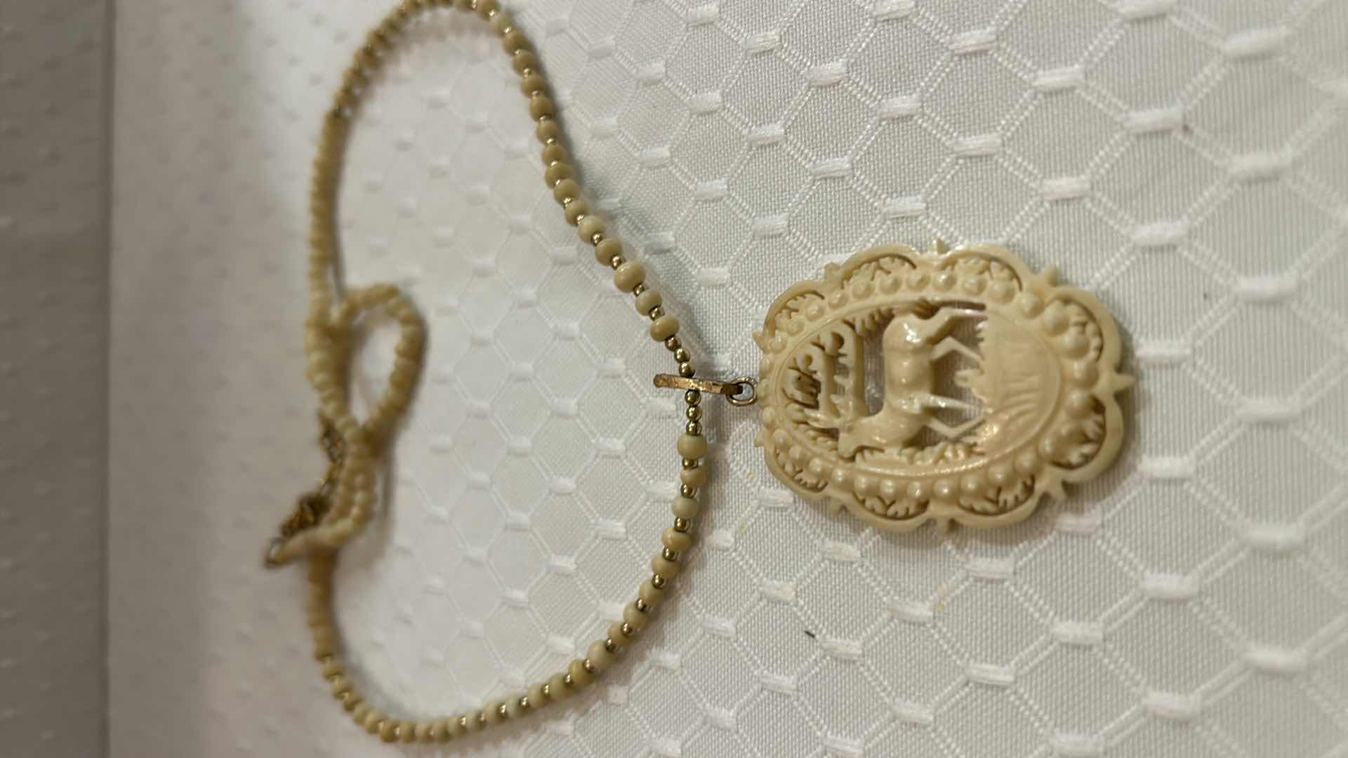 Photo 1 of JEWELRY- VINTAGE CARVED IVORY REINDEER NECKLACE.