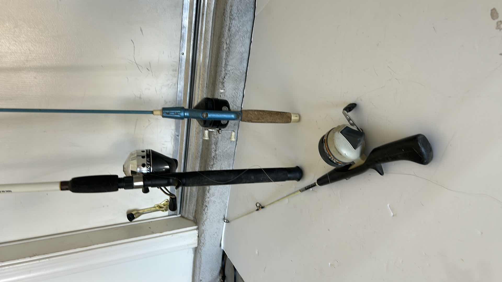 Photo 1 of THREE FISHING RODS AND REELS